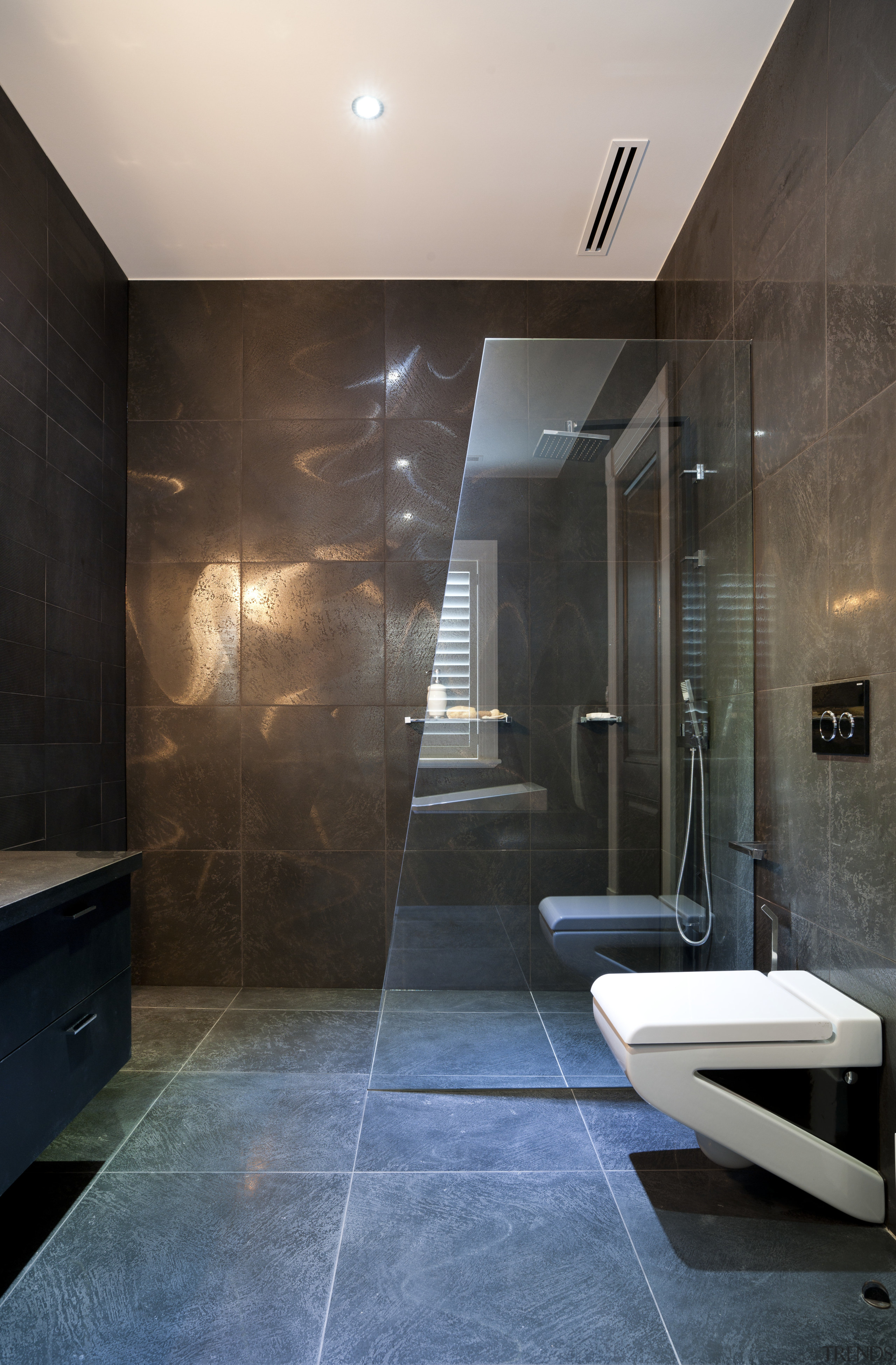 Bathroom with grey floor and walls. - Bathroom architecture, bathroom, ceiling, floor, flooring, glass, house, interior design, lighting, room, tile, wall, black, gray