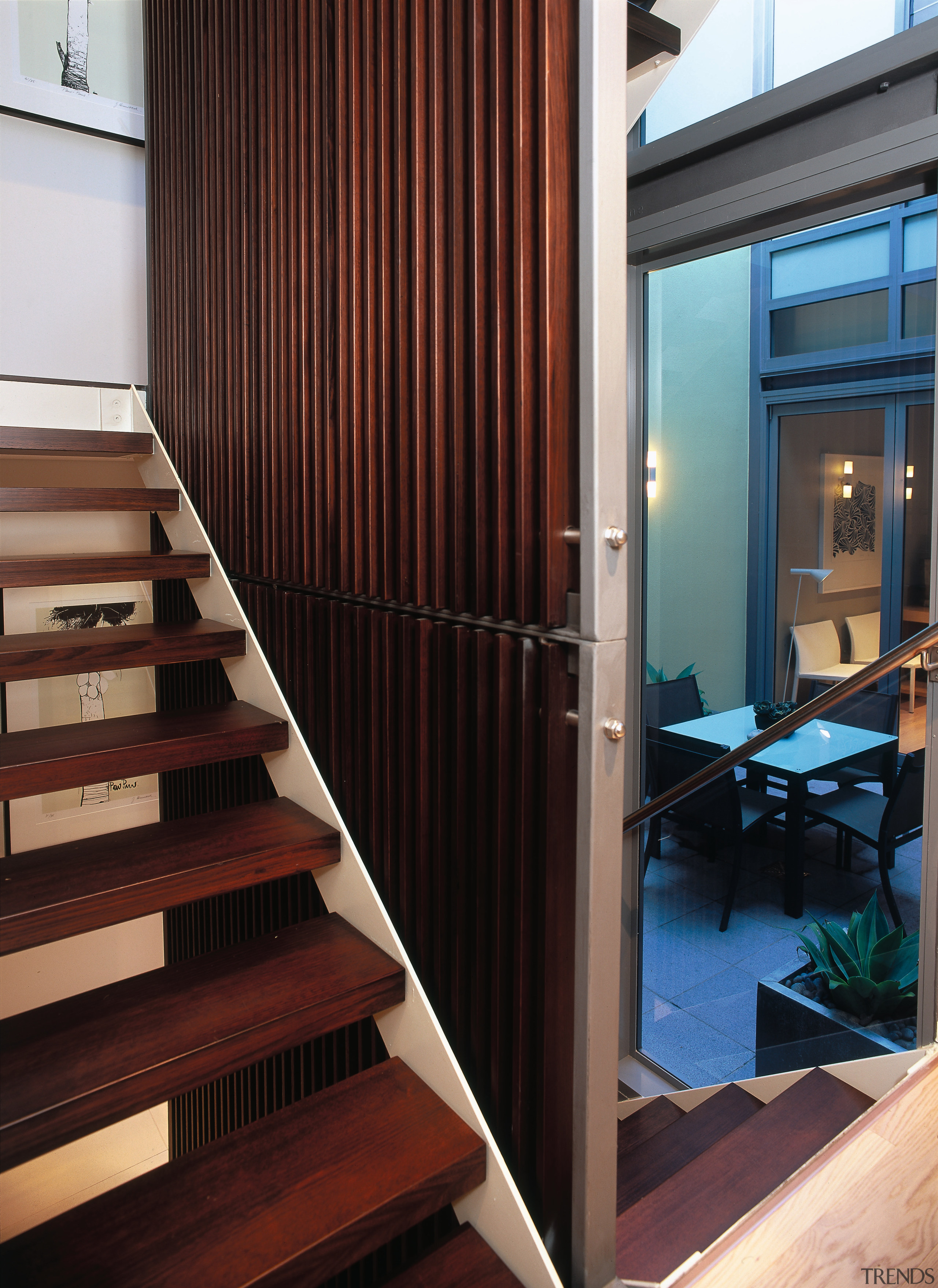 A view of a wooden stairway and wall. architecture, floor, flooring, handrail, house, interior design, stairs, wood, red