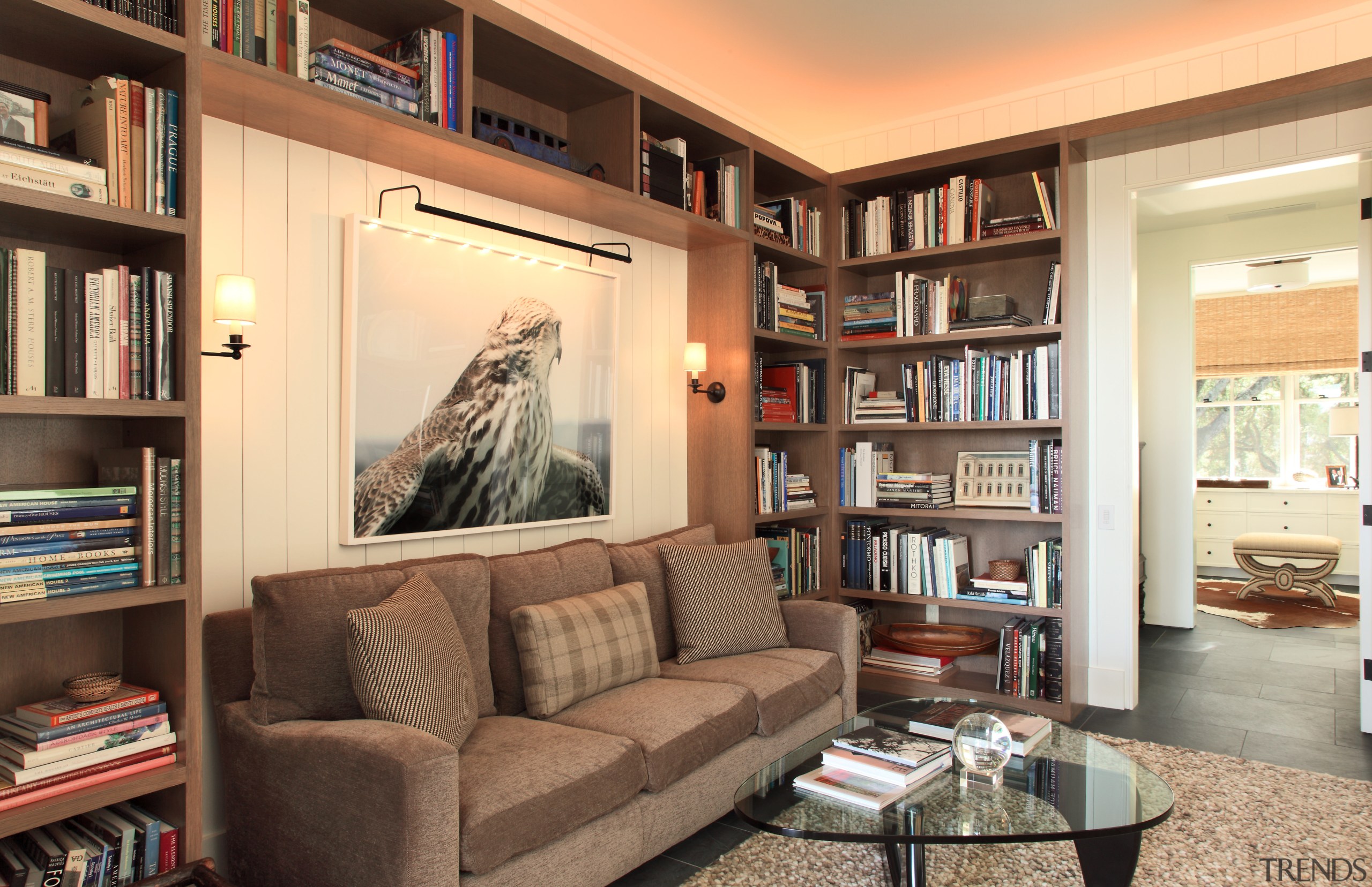 Lounge area with brown sofa and glass table, bookcase, furniture, home, interior design, library, living room, real estate, room, shelf, shelving, orange, brown