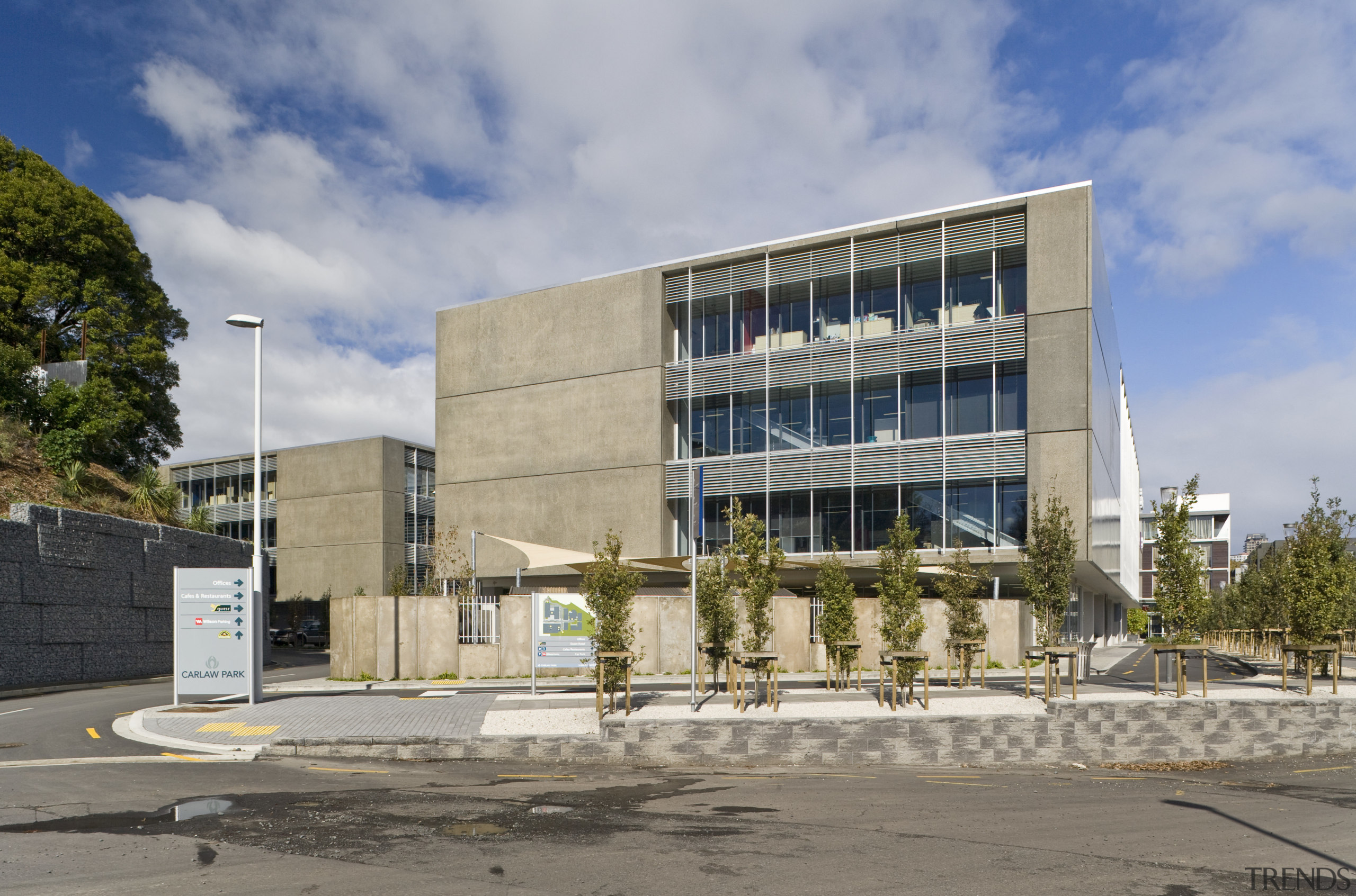 Exterior view of a commercial building in the architecture, building, commercial building, condominium, corporate headquarters, daytime, facade, headquarters, house, mixed use, neighbourhood, real estate, residential area, sky, gray