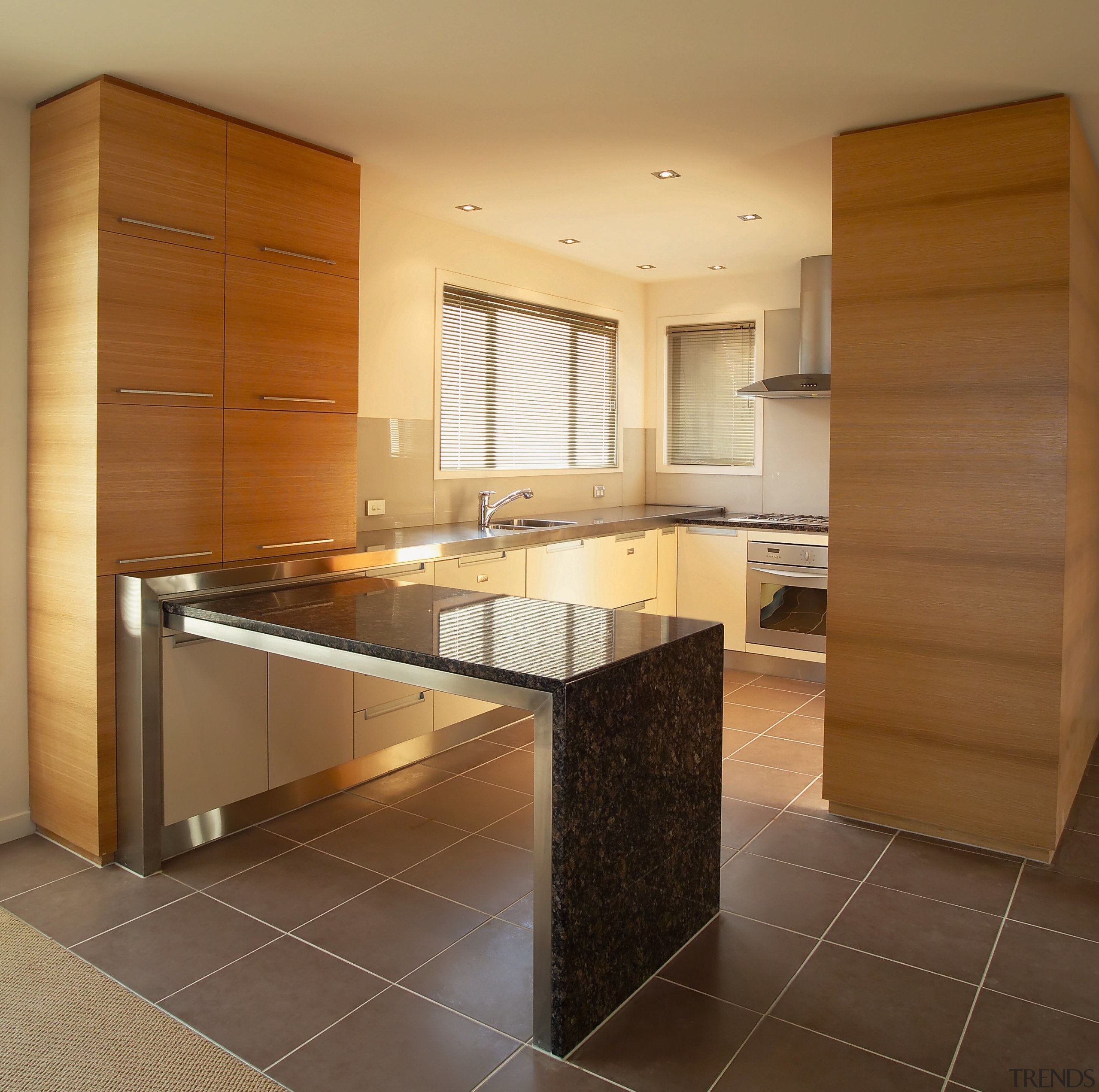 A view of a kitchen area, black tiled cabinetry, countertop, cuisine classique, floor, flooring, interior design, kitchen, real estate, room, brown, orange