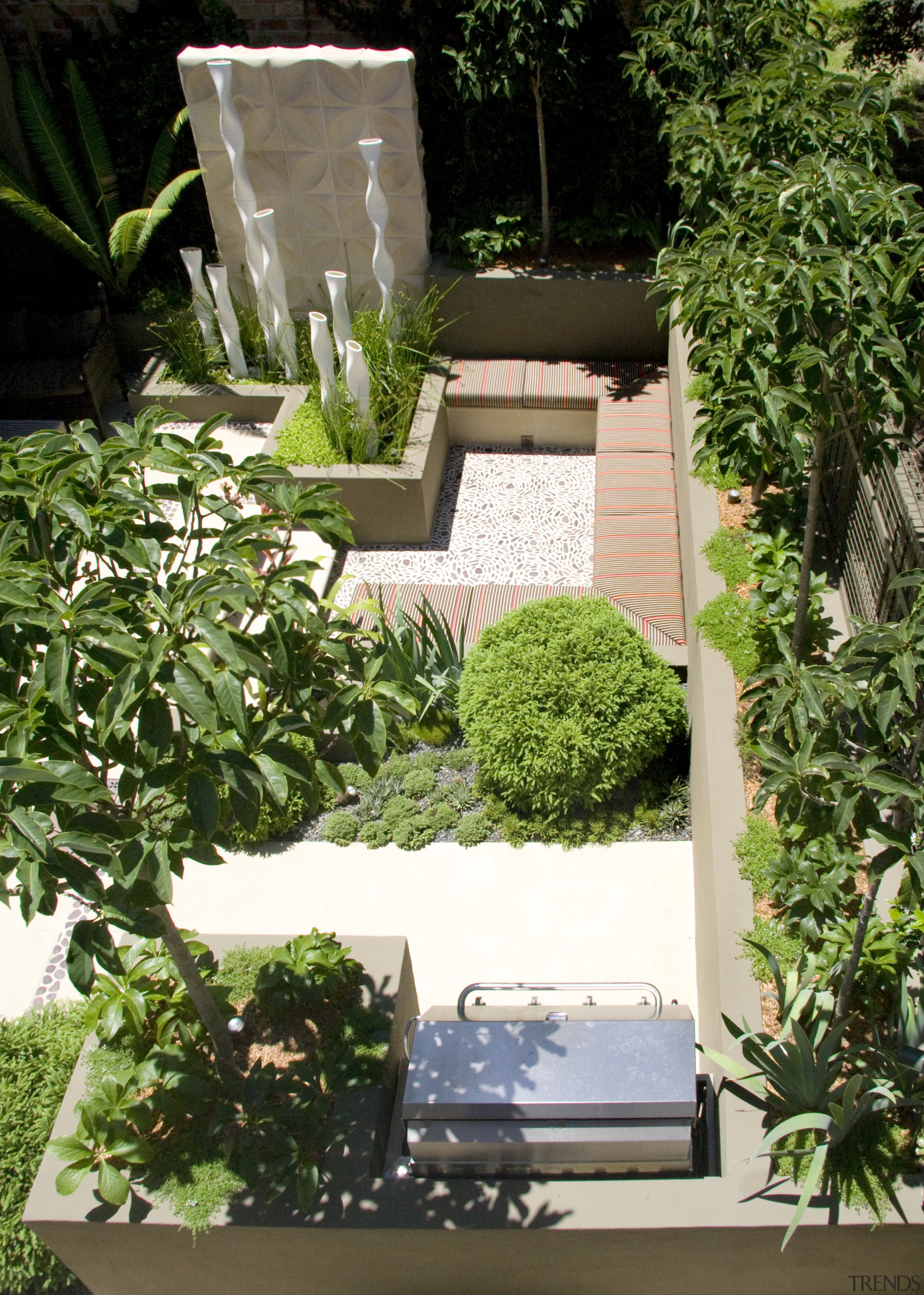 View of outdoor living area and courtyard featuring courtyard, flowerpot, garden, herb, houseplant, plant, tree, yard, green, brown