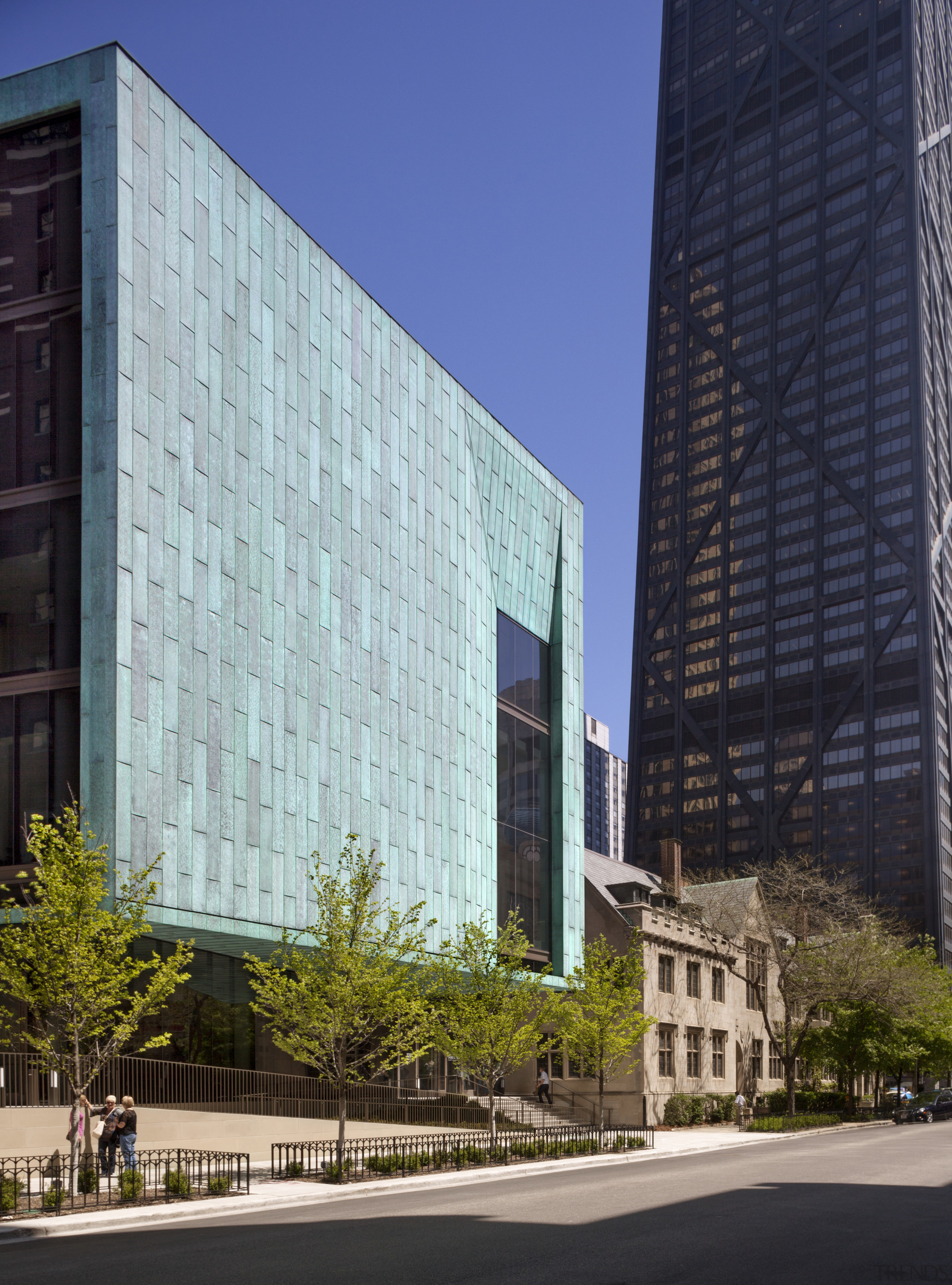 Part of a contemporary addition to a traditional architecture, building, city, commercial building, condominium, corporate headquarters, daytime, downtown, facade, headquarters, landmark, metropolis, metropolitan area, mixed use, neighbourhood, reflection, sky, skyscraper, tower block, urban area, blue, gray