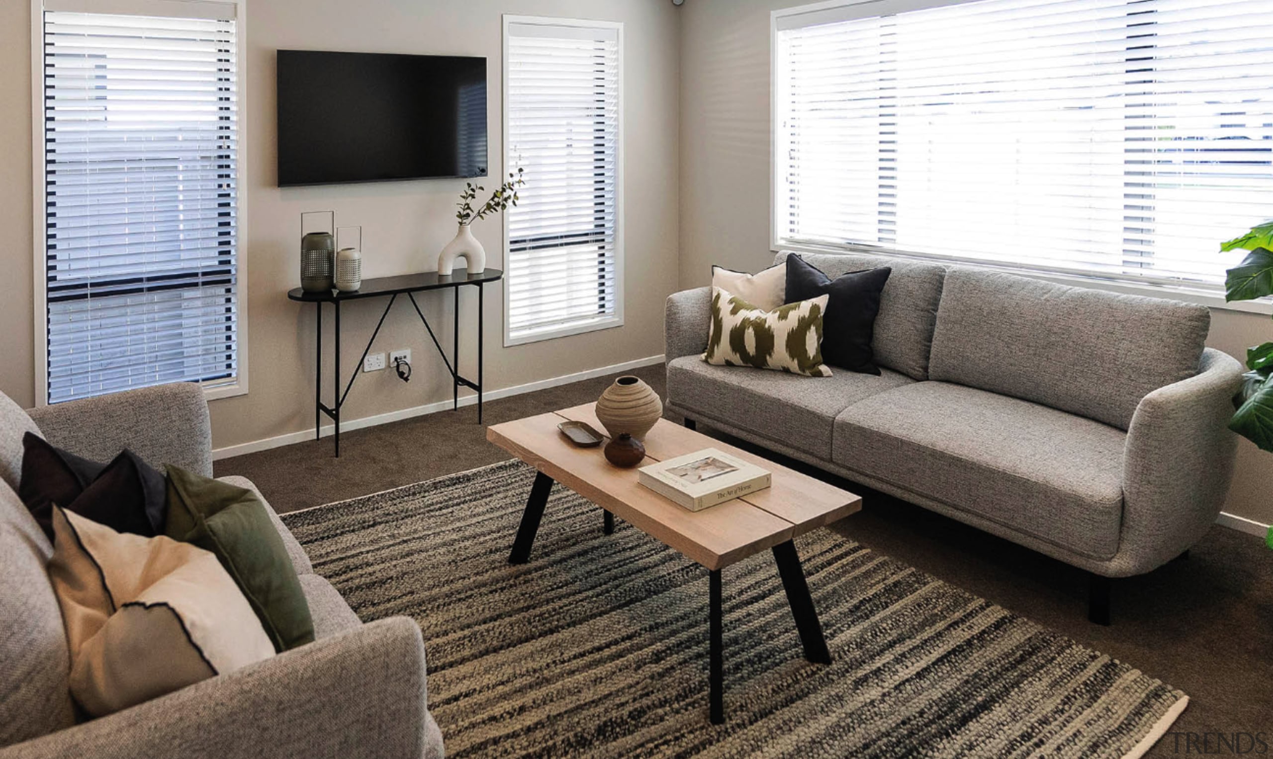 Carpeted front living room with expansive glazing on 
