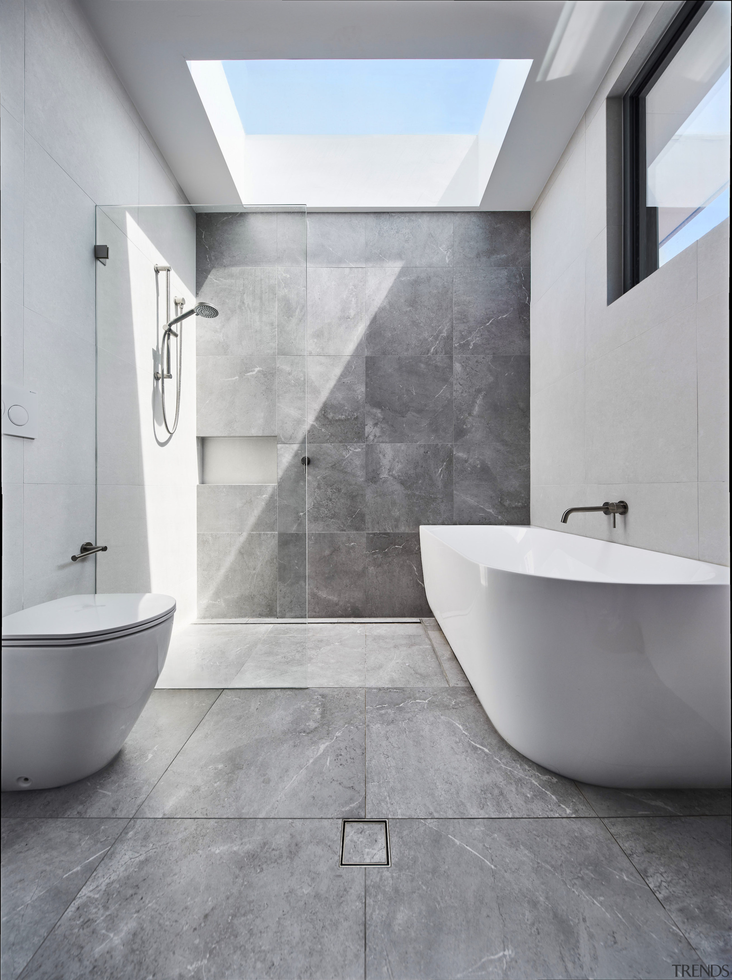 A large skylight showers the family bathroom in 