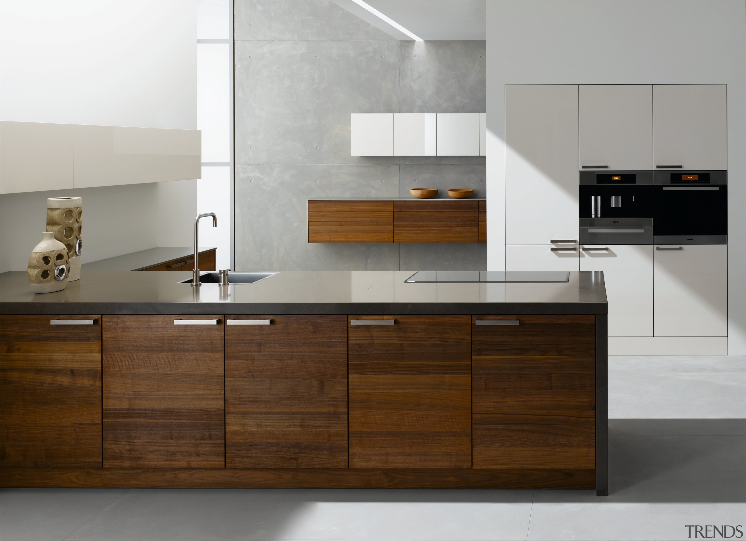 A view of this kitchen featuring Sleek contemporary cabinetry, chest of drawers, countertop, cuisine classique, floor, furniture, interior design, kitchen, product, product design, sink, gray, brown
