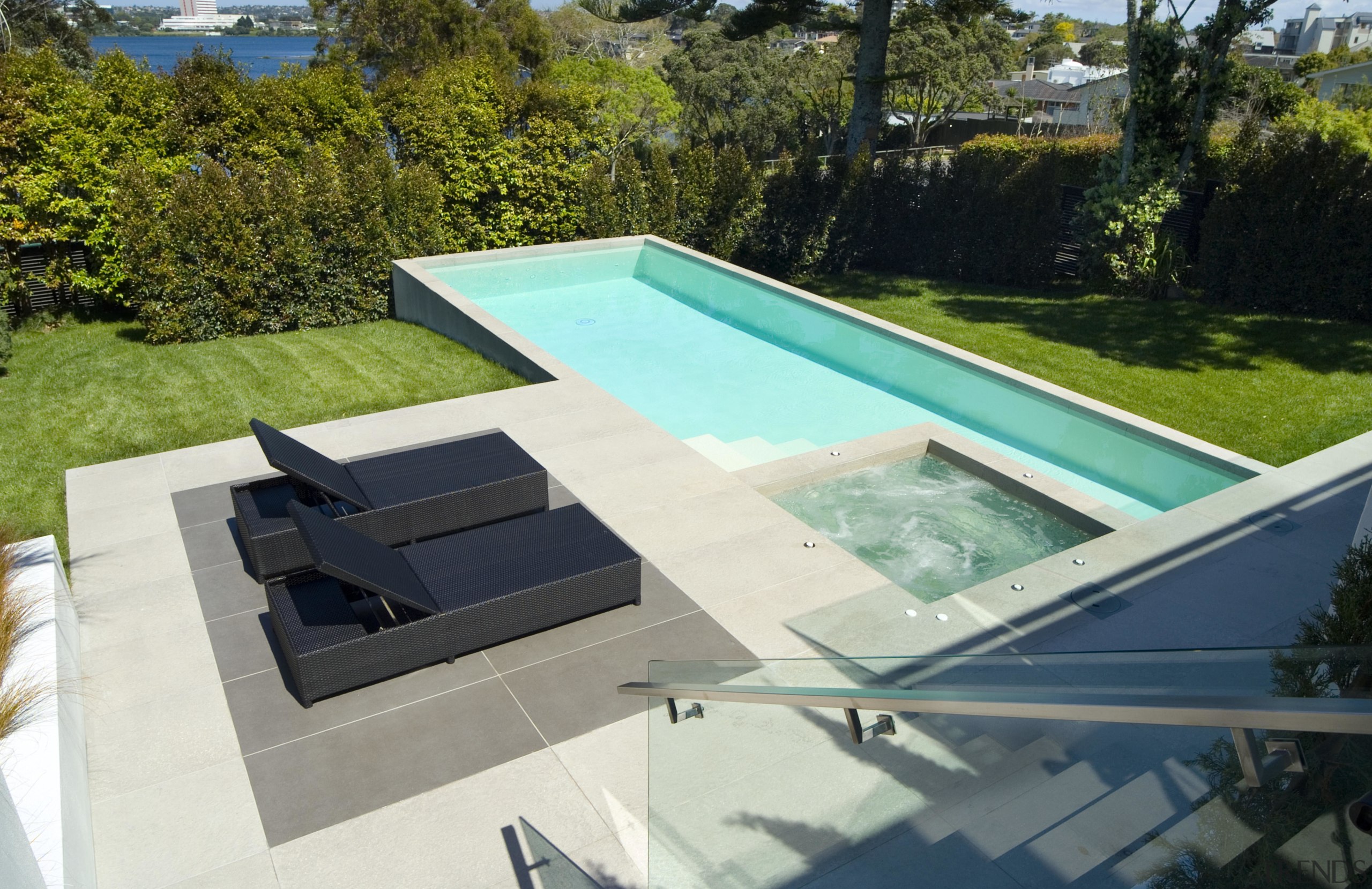 A view of a swimming pool by Mayfair backyard, daylighting, leisure, outdoor furniture, property, roof, sunlounger, swimming pool, water