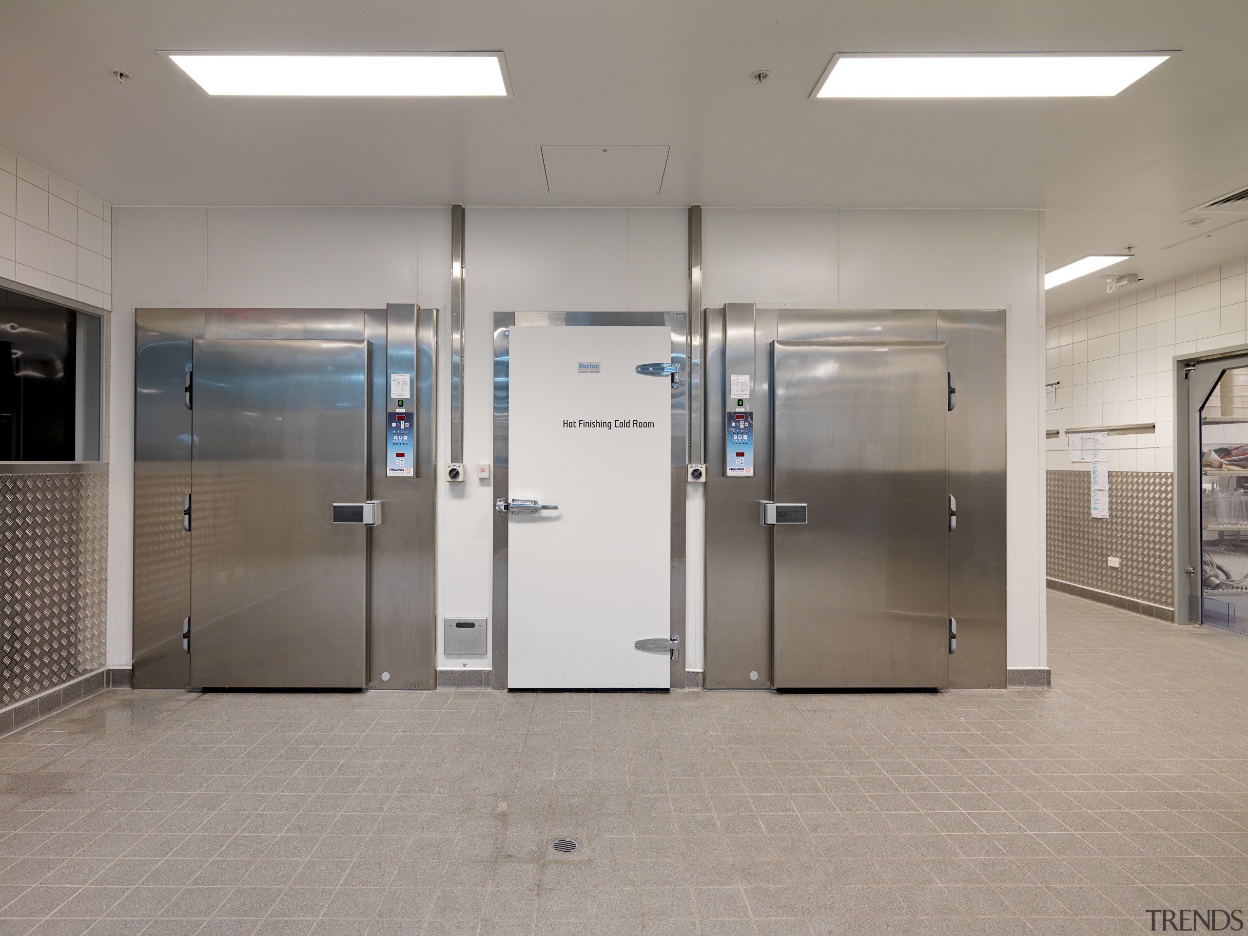 View of the 100m long production kitchen of door, floor, glass, gray