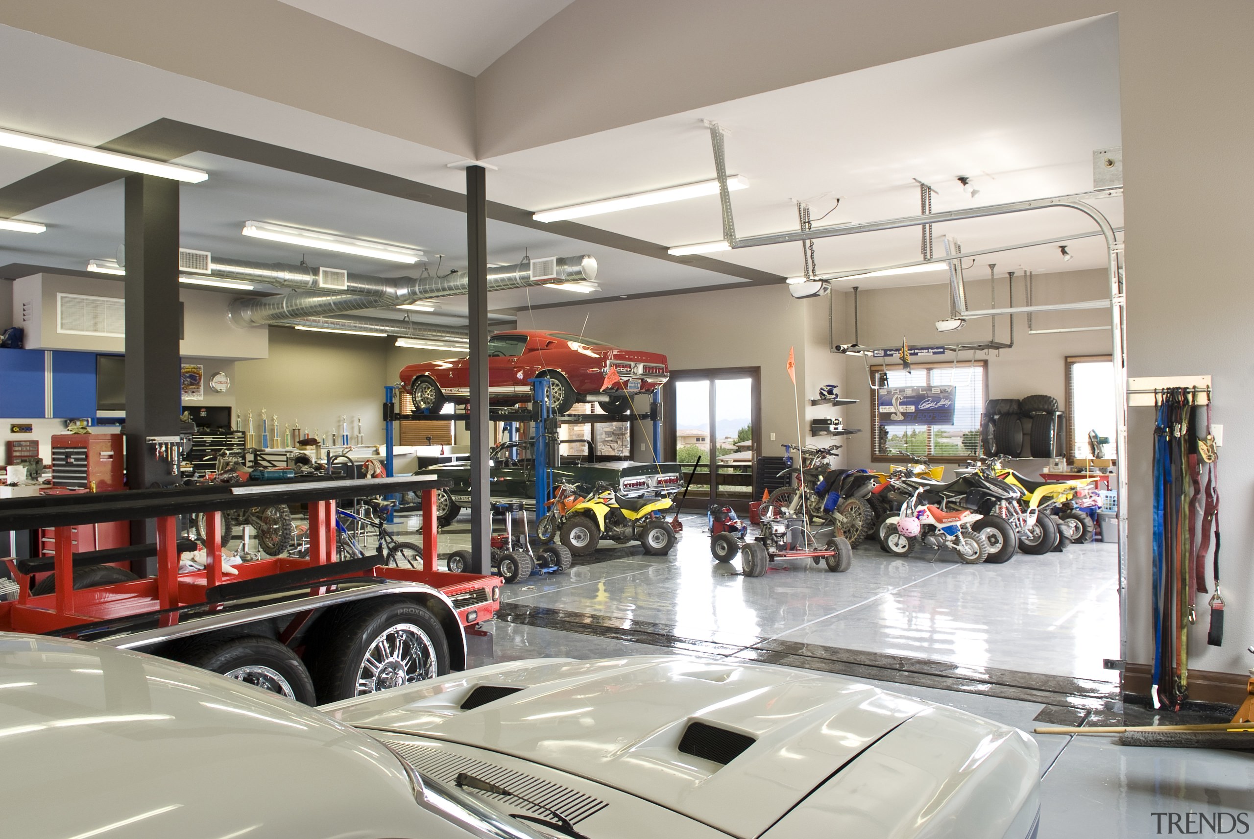 View of the garage which features exterior windows automobile repair shop, retail, gray