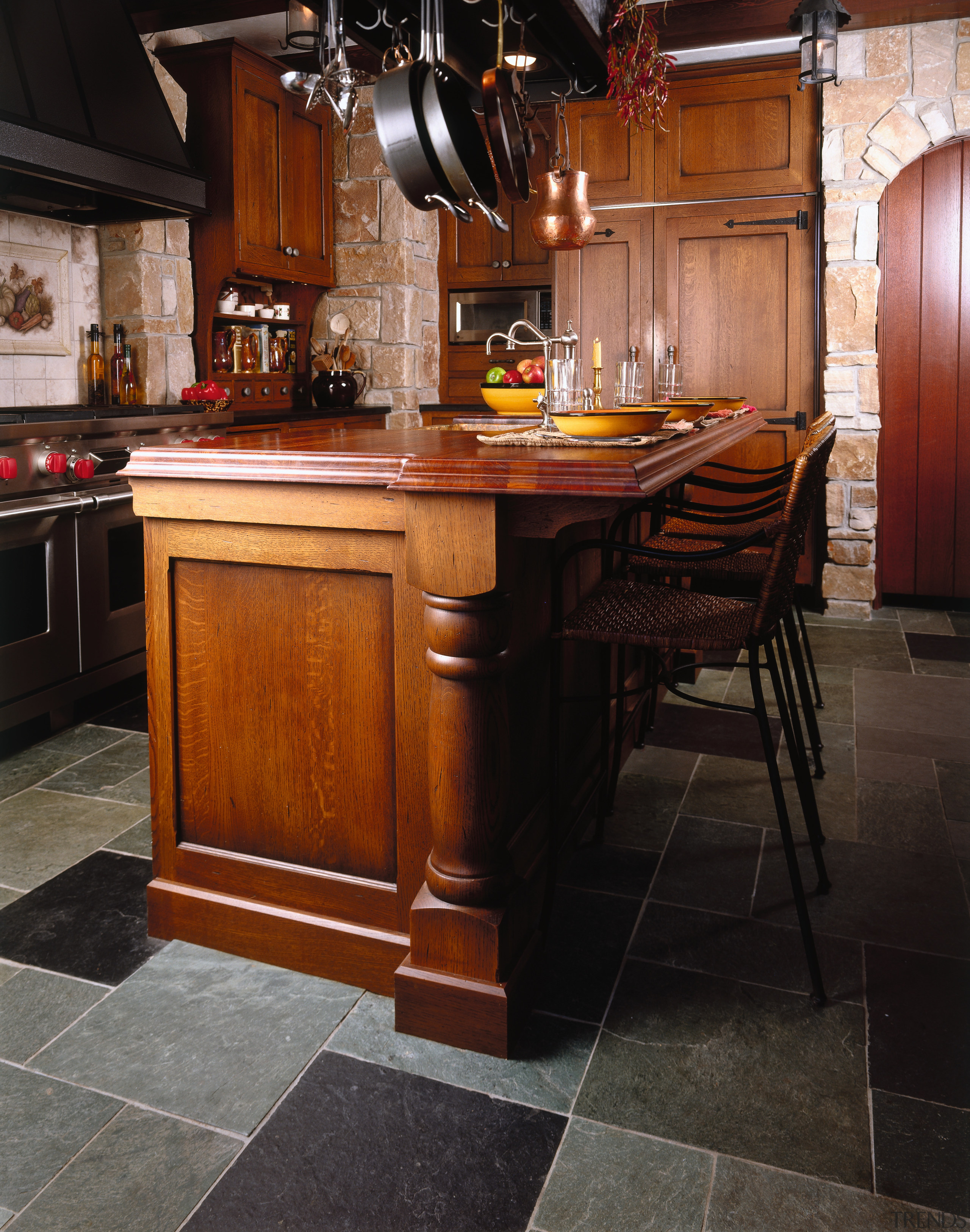 view of this kitchen that features a large cabinetry, countertop, cuisine classique, floor, flooring, furniture, hardwood, interior design, kitchen, room, table, wood, wood flooring, wood stain, black