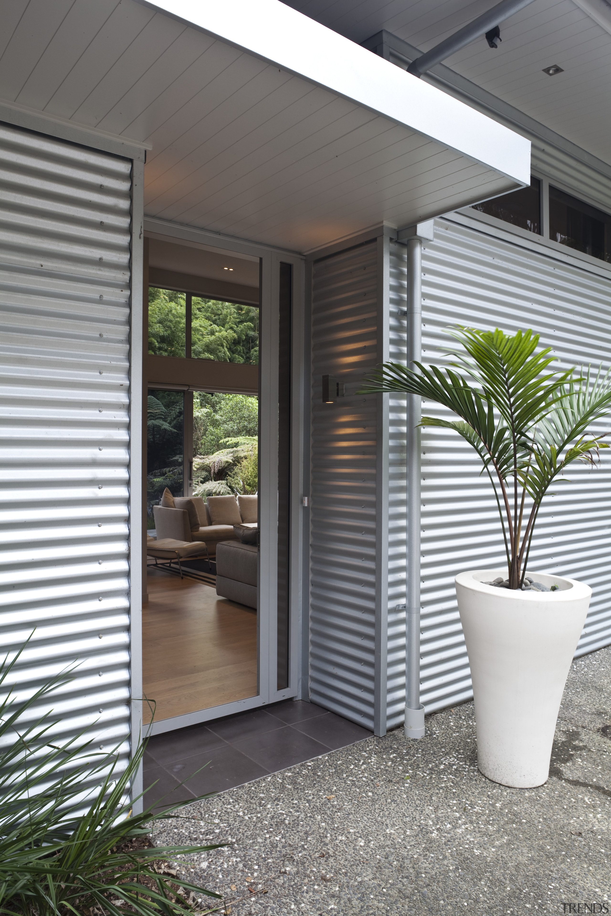 Entrance way of contemporary home surrounded by trees. architecture, courtyard, door, home, house, interior design, porch, real estate, siding, window, window covering, gray