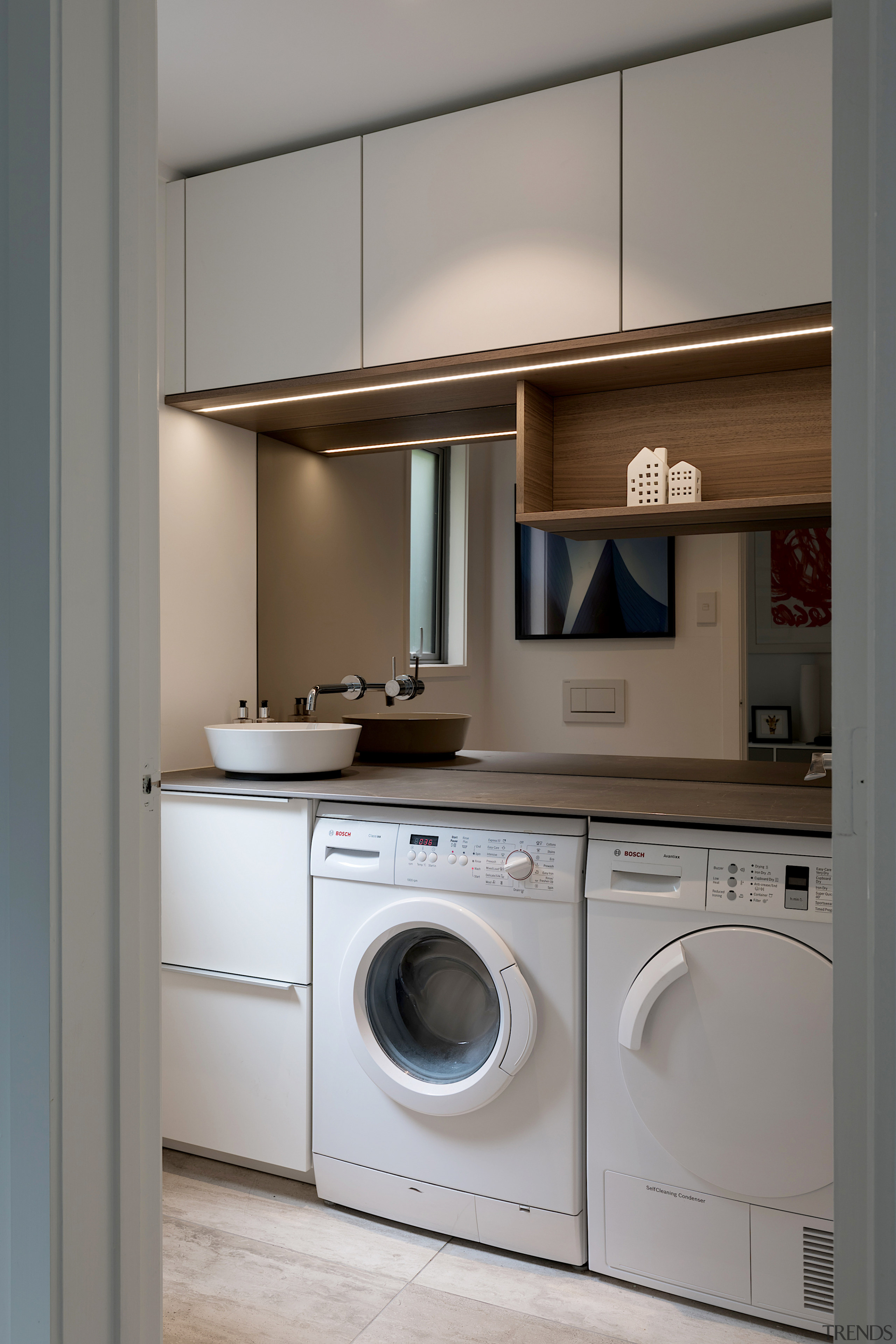 Designer Lara Farmillo designed the laundry in this architecture, building, cabinetry, clothes dryer, countertop, cupboard, floor, furniture, home appliance, house, interior design, kitchen, laundry, laundry room, major appliance, material property, property, room, washing machine, gray