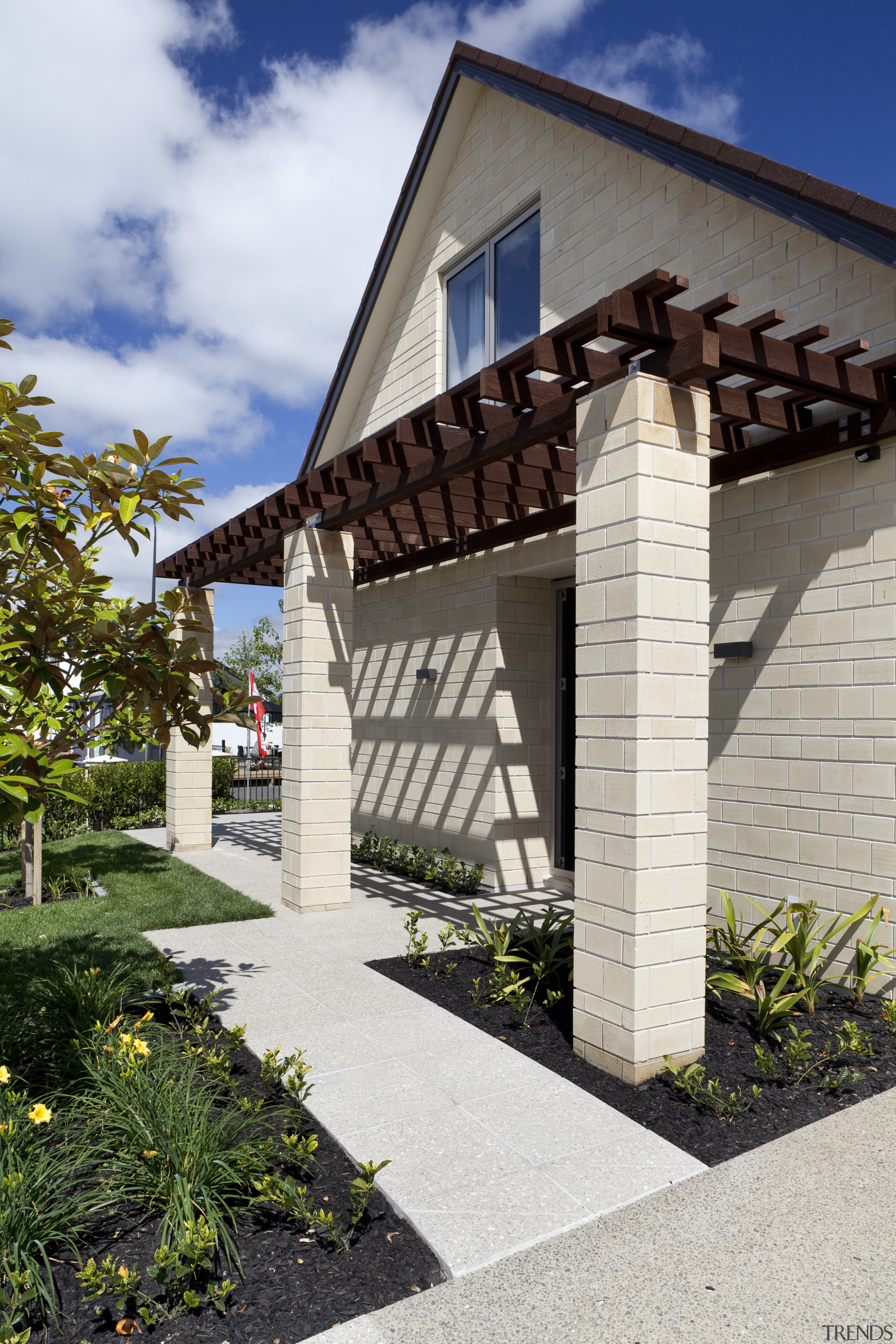 This 'Life at Home' home features paving from architecture, building, cottage, estate, facade, home, house, outdoor structure, real estate, residential area, sky, walkway, white