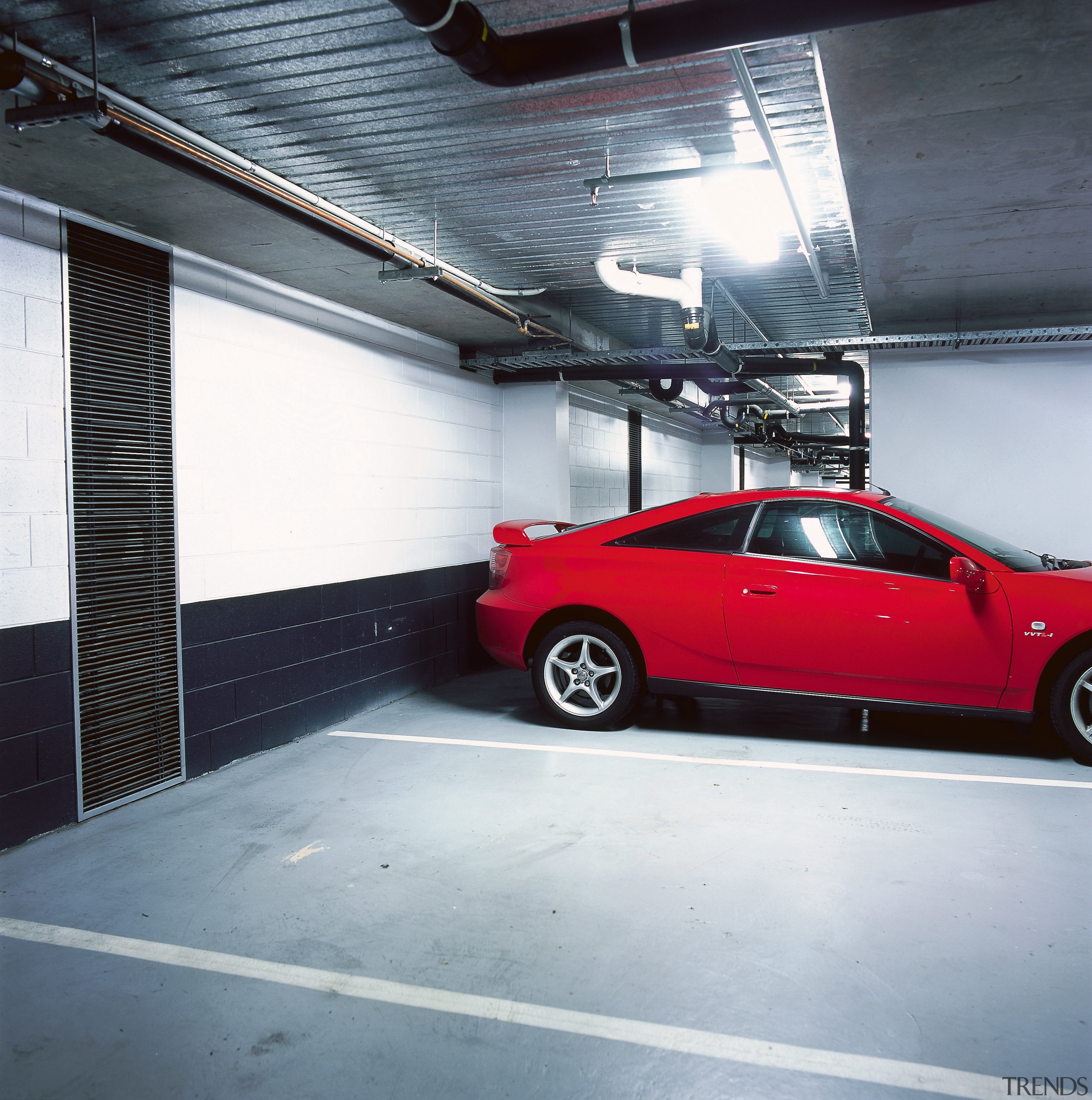 view of the large ventilation fans and ducting asphalt, auto part, automotive design, automotive exterior, automotive tire, automotive wheel system, building, bumper, car, family car, full size car, garage, luxury vehicle, mid size car, mode of transport, motor vehicle, parking, parking lot, performance car, red, rim, sedan, sports car, technology, tire, vehicle, vehicle door, wheel, gray