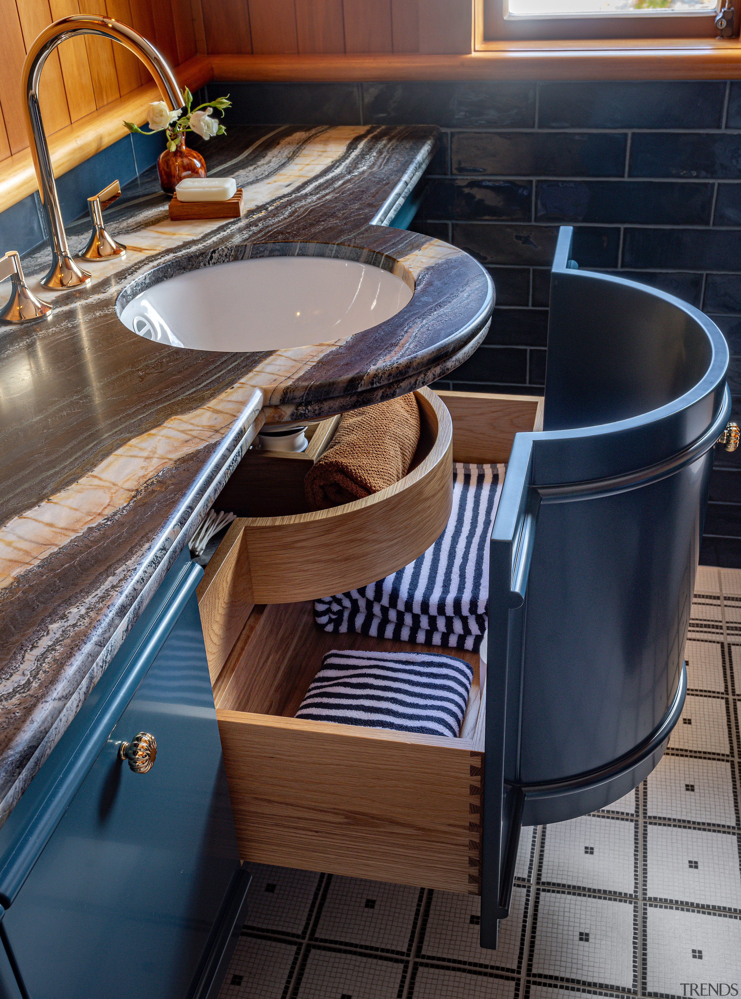 The crafted cabinetry follows the curvaceous cue of 