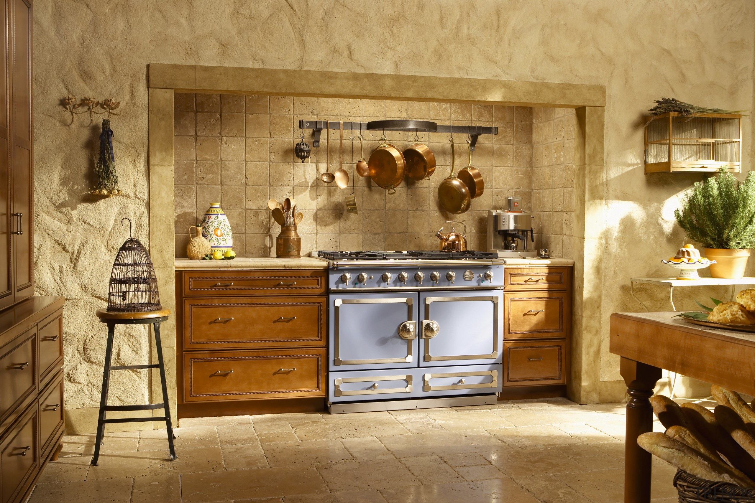 Traditional style kitchen with wood cabinetry, stone walls cabinetry, countertop, cuisine classique, furniture, interior design, kitchen, room, brown, orange