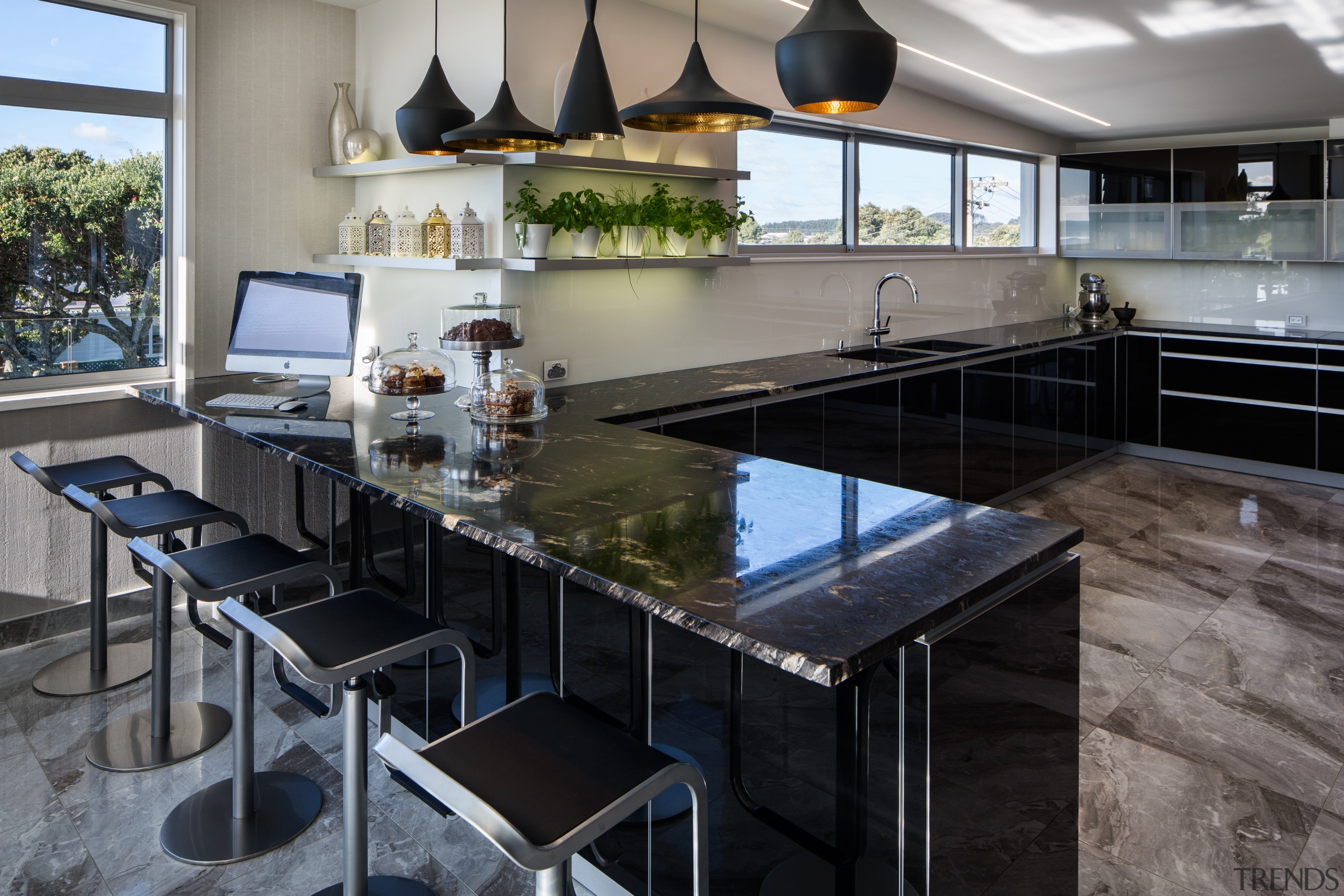 The large seating area acts as a servery countertop, interior design, kitchen, real estate, gray, black