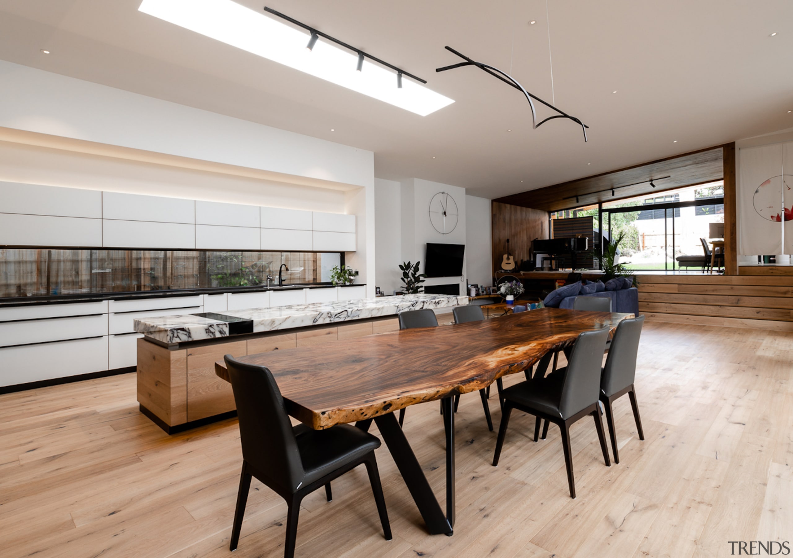 The kitchen island runs adjacent to the timber 