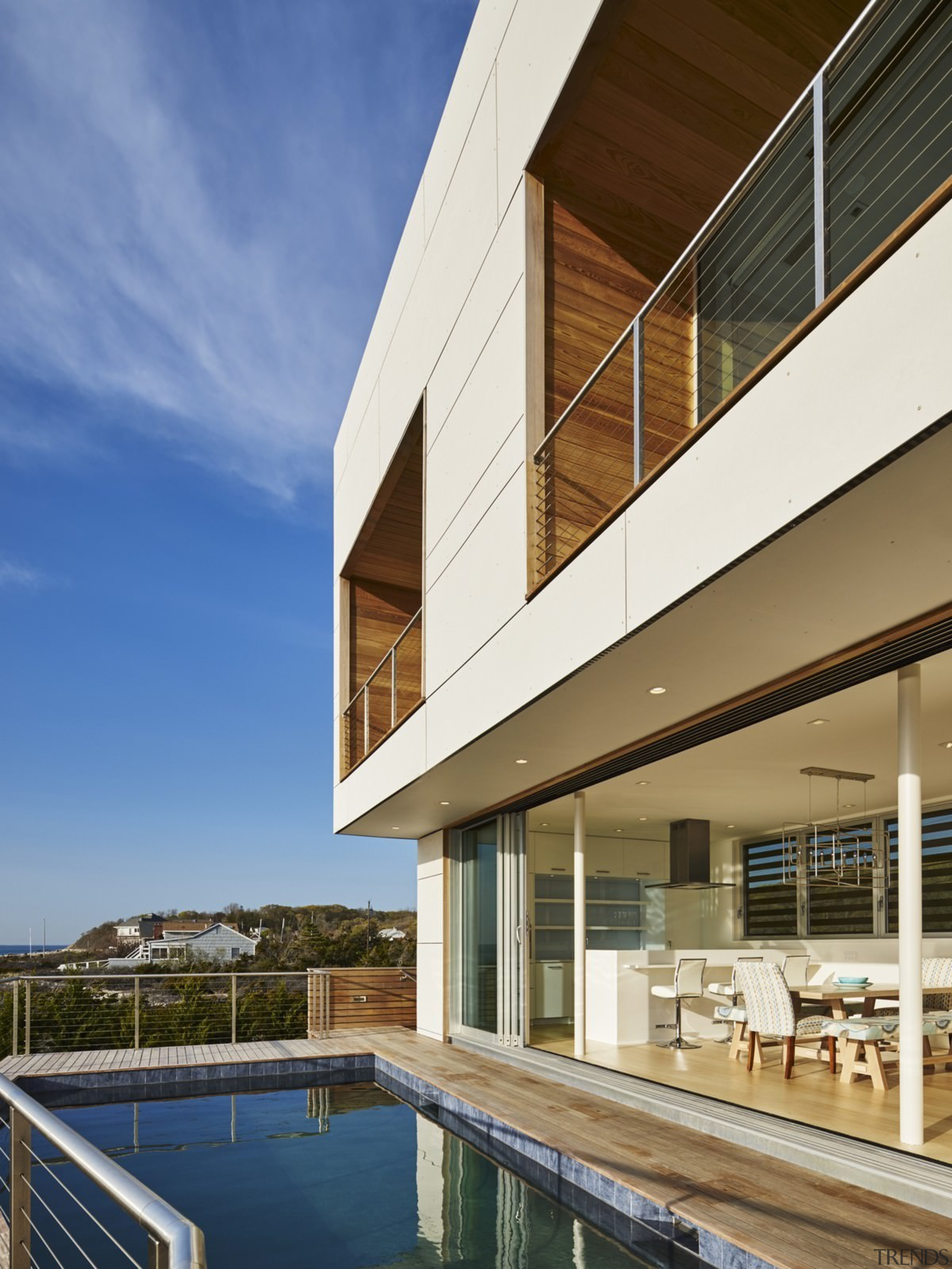 Wood panels and wood soffits line the upper apartment, architecture, building, condominium, corporate headquarters, daylighting, estate, facade, home, house, property, real estate, reflection, residential area, sky, window, brown, blue