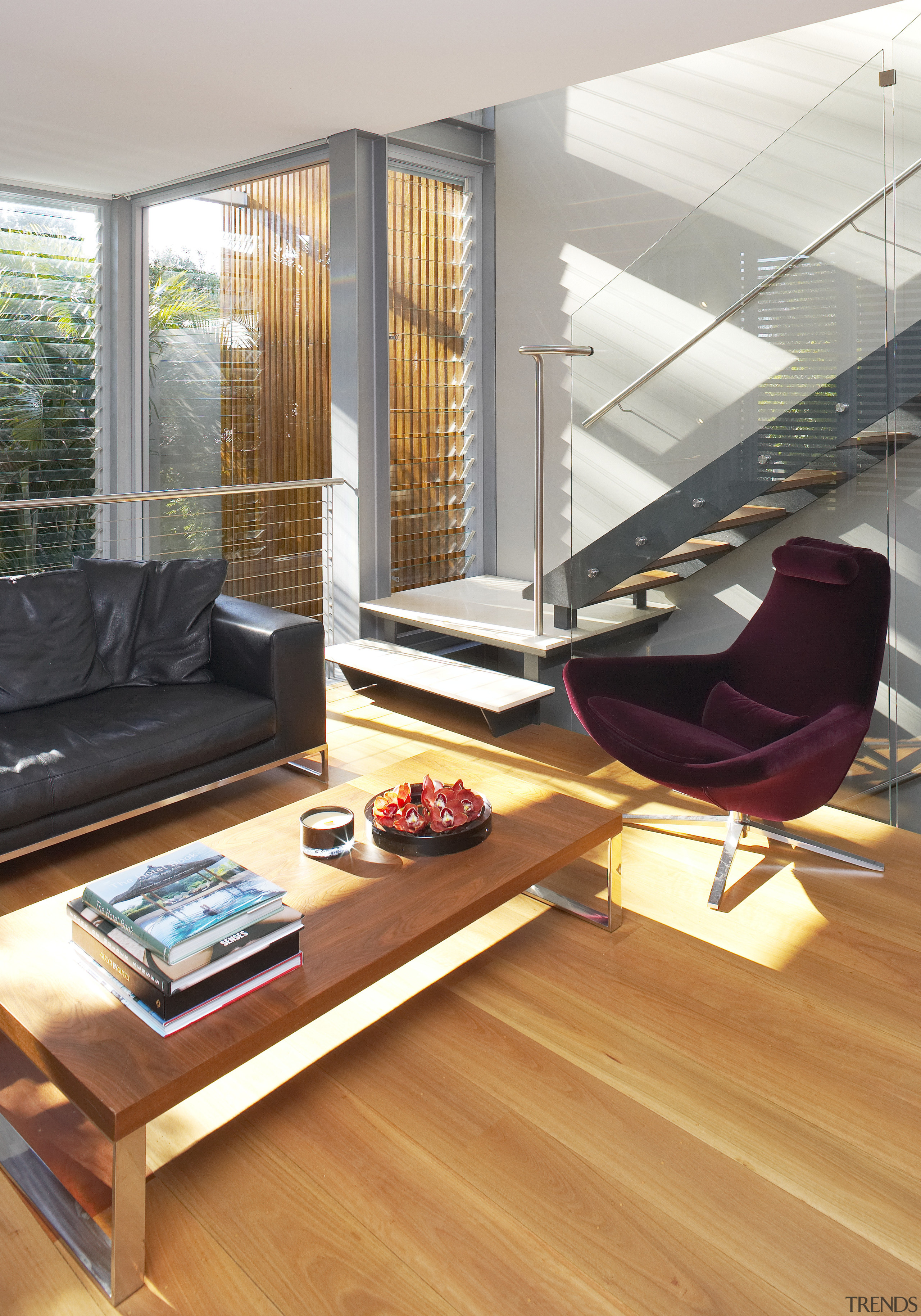 A glazed, three-storey atrium fills this home with chair, floor, flooring, furniture, hardwood, home, house, interior design, laminate flooring, living room, table, window, wood, wood flooring, white, orange