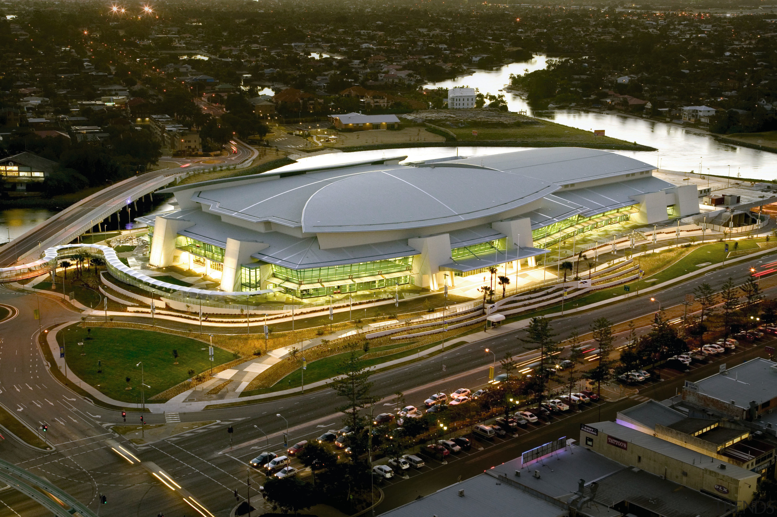 View looking down at large multi-functional complex with aerial photography, arena, bird's eye view, city, sport venue, stadium, structure, urban area, brown