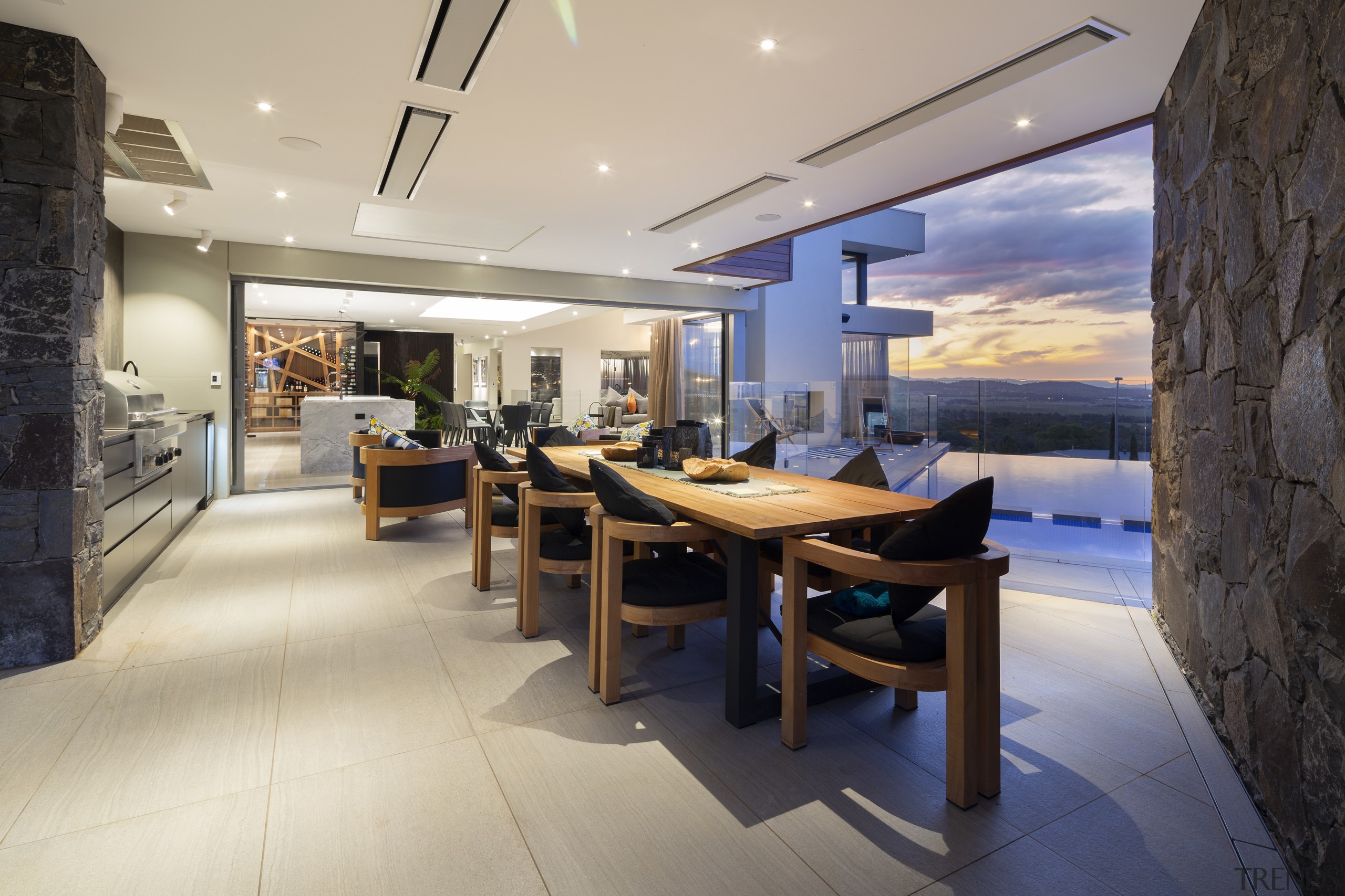 The outdoor dining area with feature indoor wine 