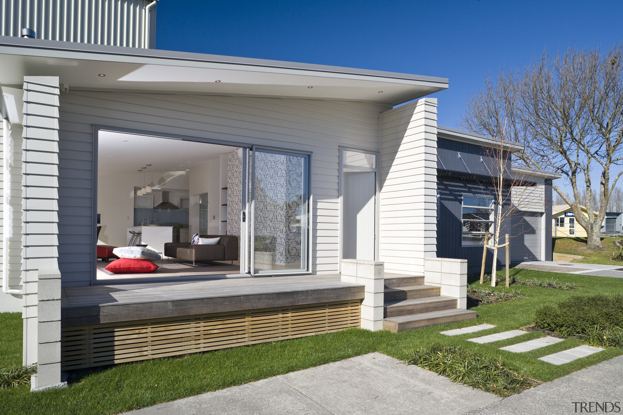 Exterior view of a Harmony Homes show home cottage, elevation, facade, home, house, luxury vehicle, property, real estate, residential area, siding, window, gray