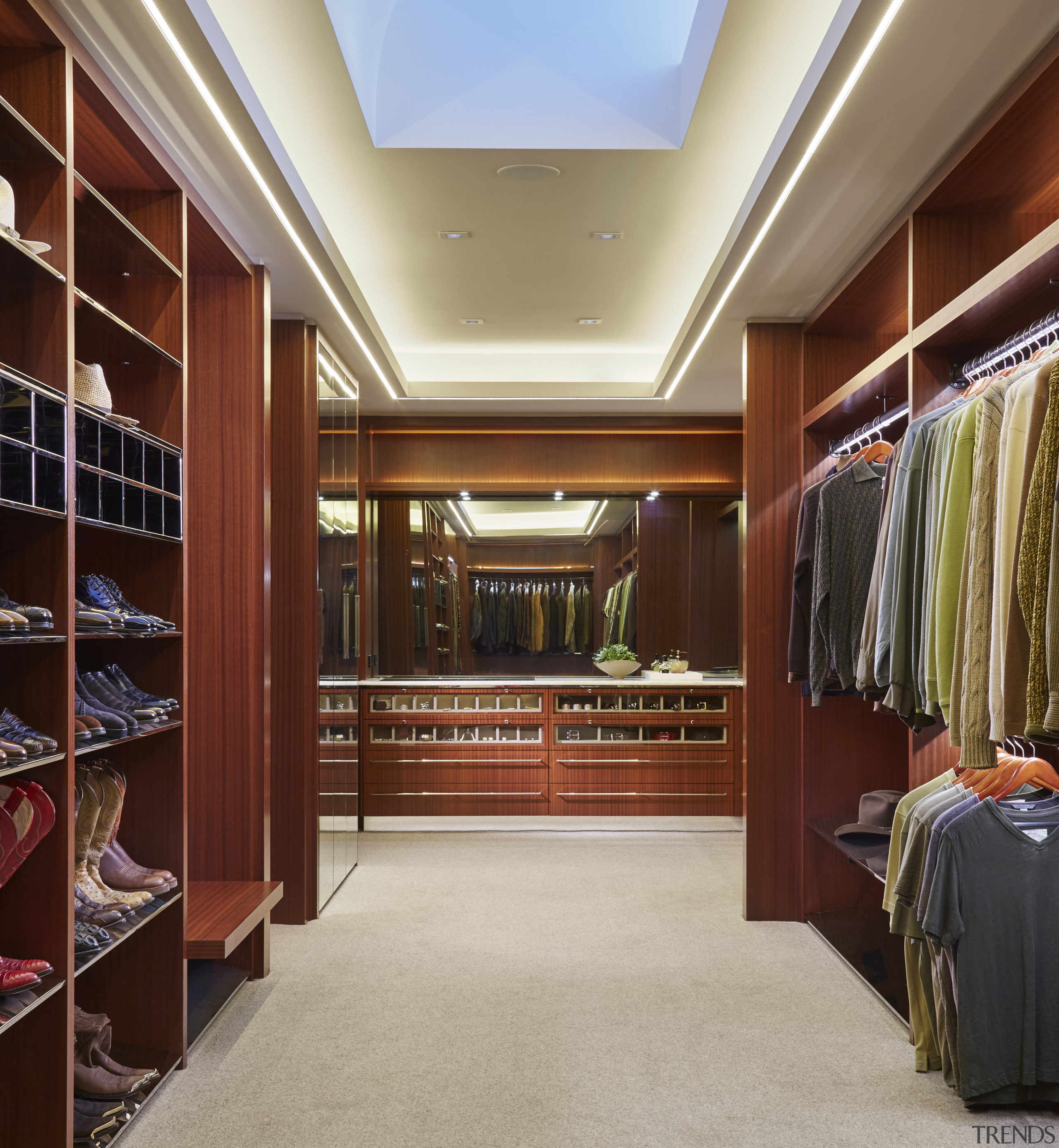 With no windows, this large closet is the bookcase, cabinetry, ceiling, closet, flooring, furniture, interior design, lobby, room, wardrobe, red, gray