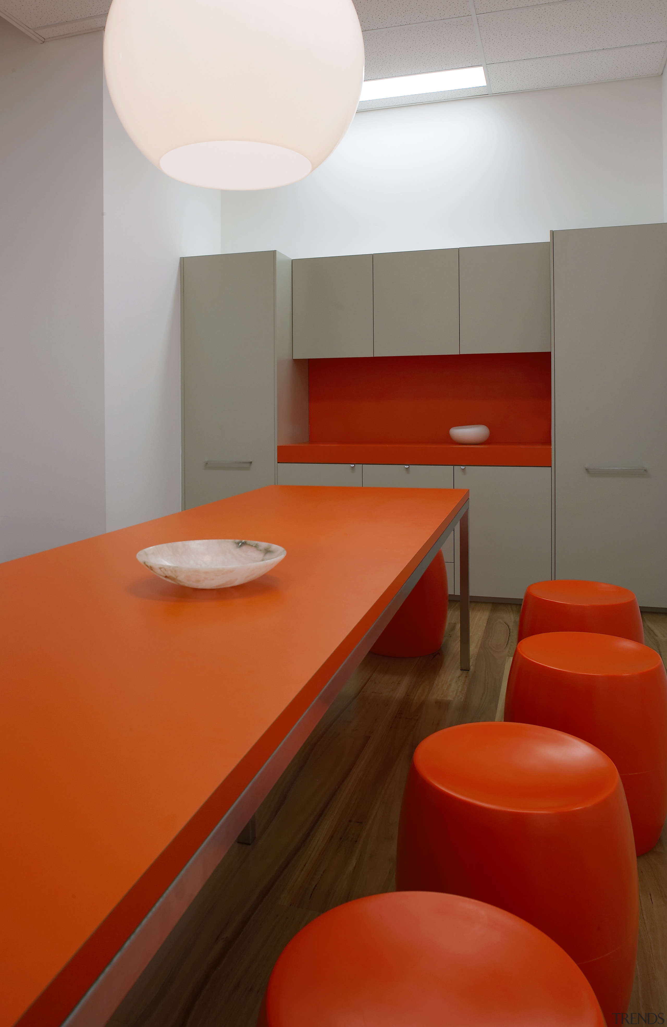 view of the lunch room which features table ceiling, chair, floor, flooring, furniture, interior design, light, light fixture, lighting, orange, product design, table, red, gray
