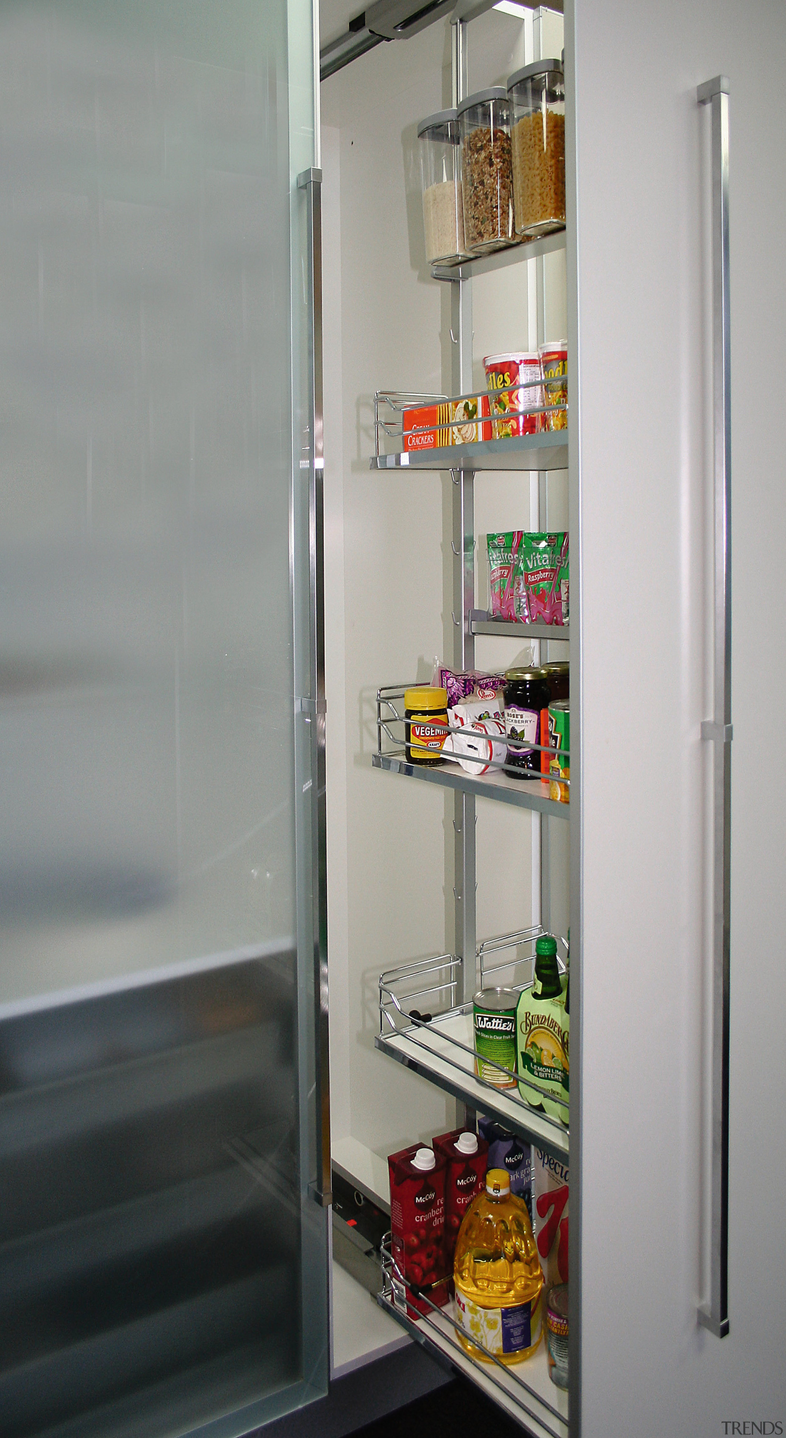 A view of this kitchen featuring cabinetry and display case, home appliance, kitchen appliance, major appliance, product, refrigerator, shelf, shelving, gray