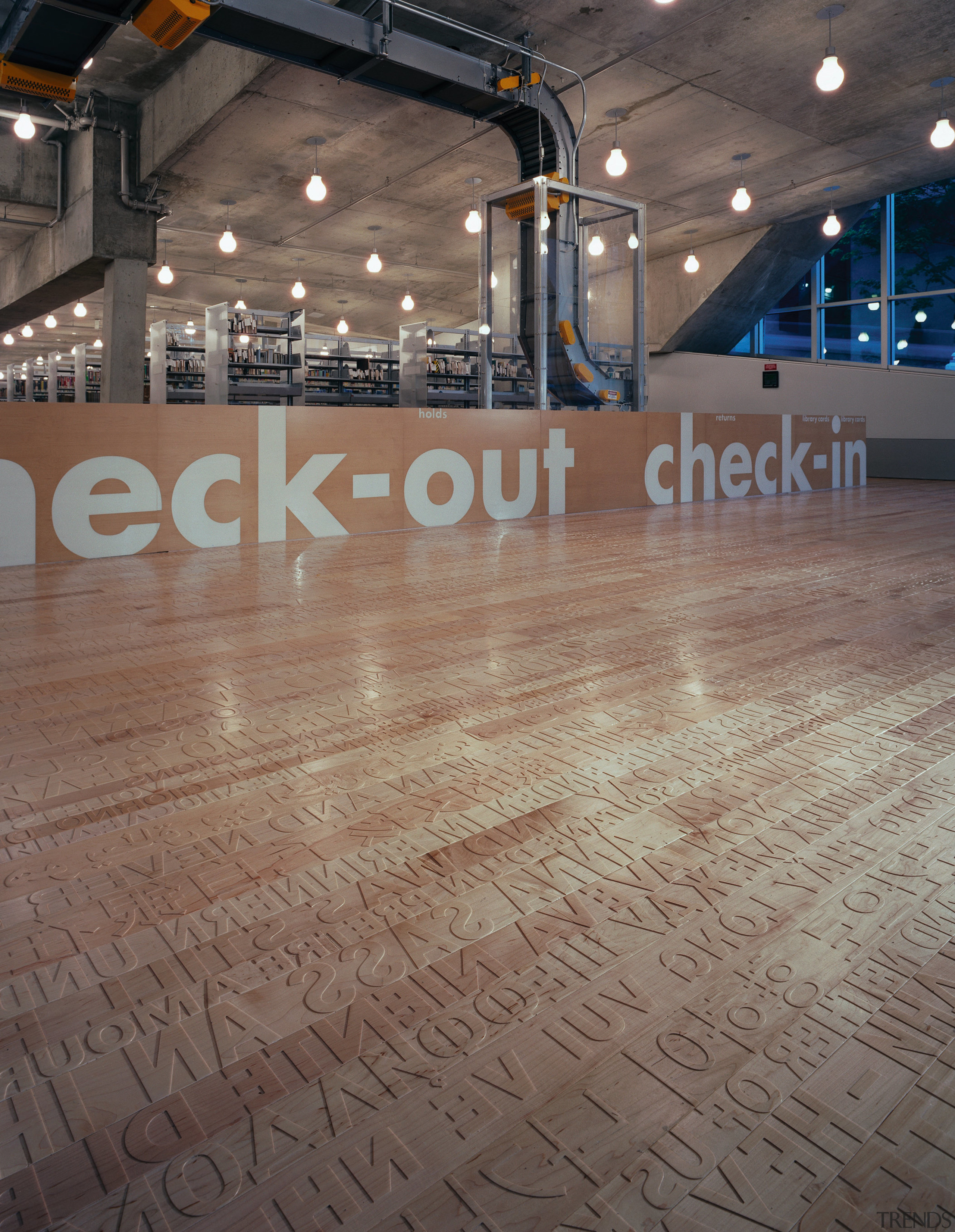 View of the check out area, large brown floor, flooring, hardwood, light, structure, wood, gray, brown