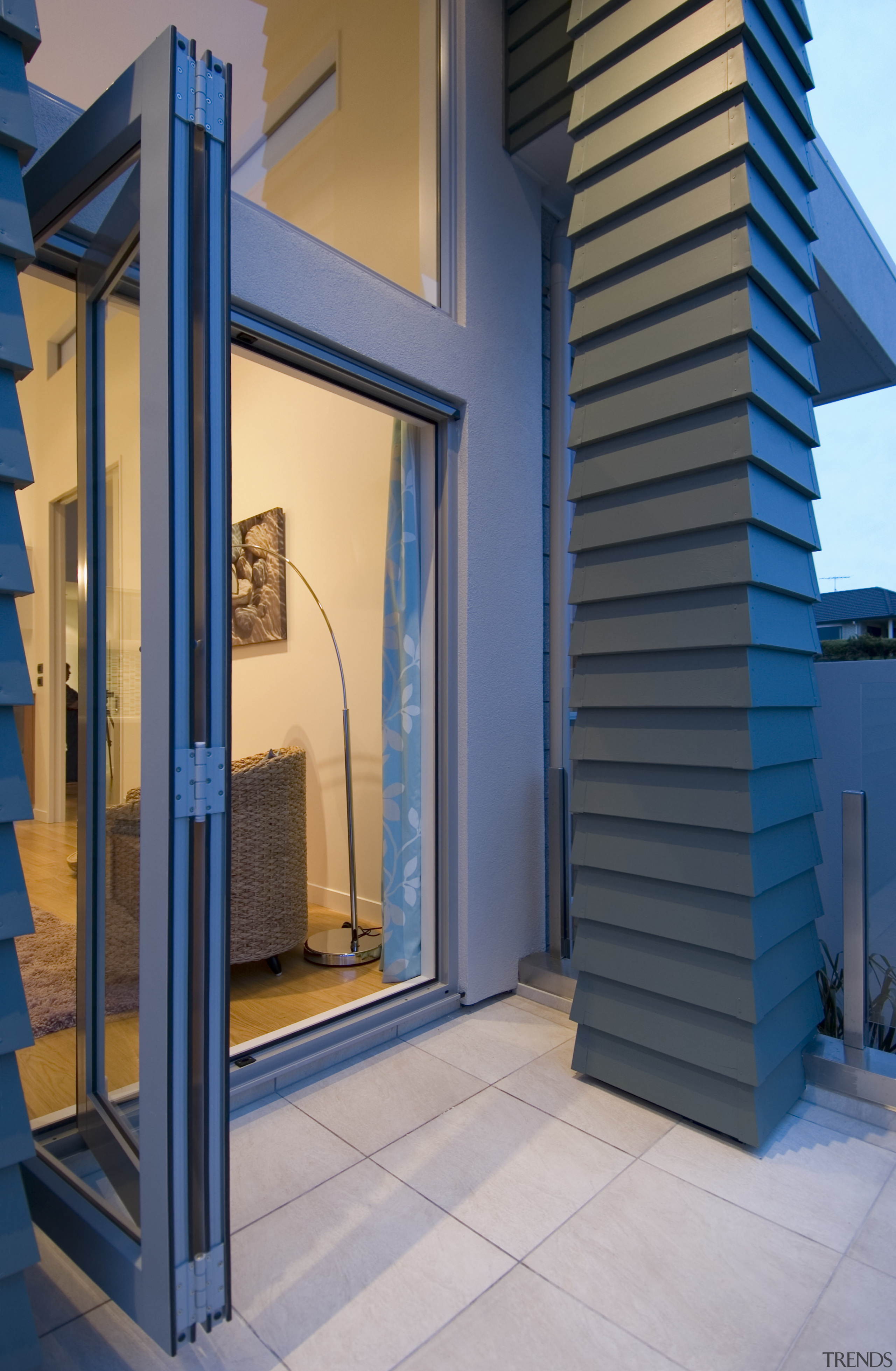 Large bifold doors lead from the open-plan living architecture, facade, home, structure, blue, gray