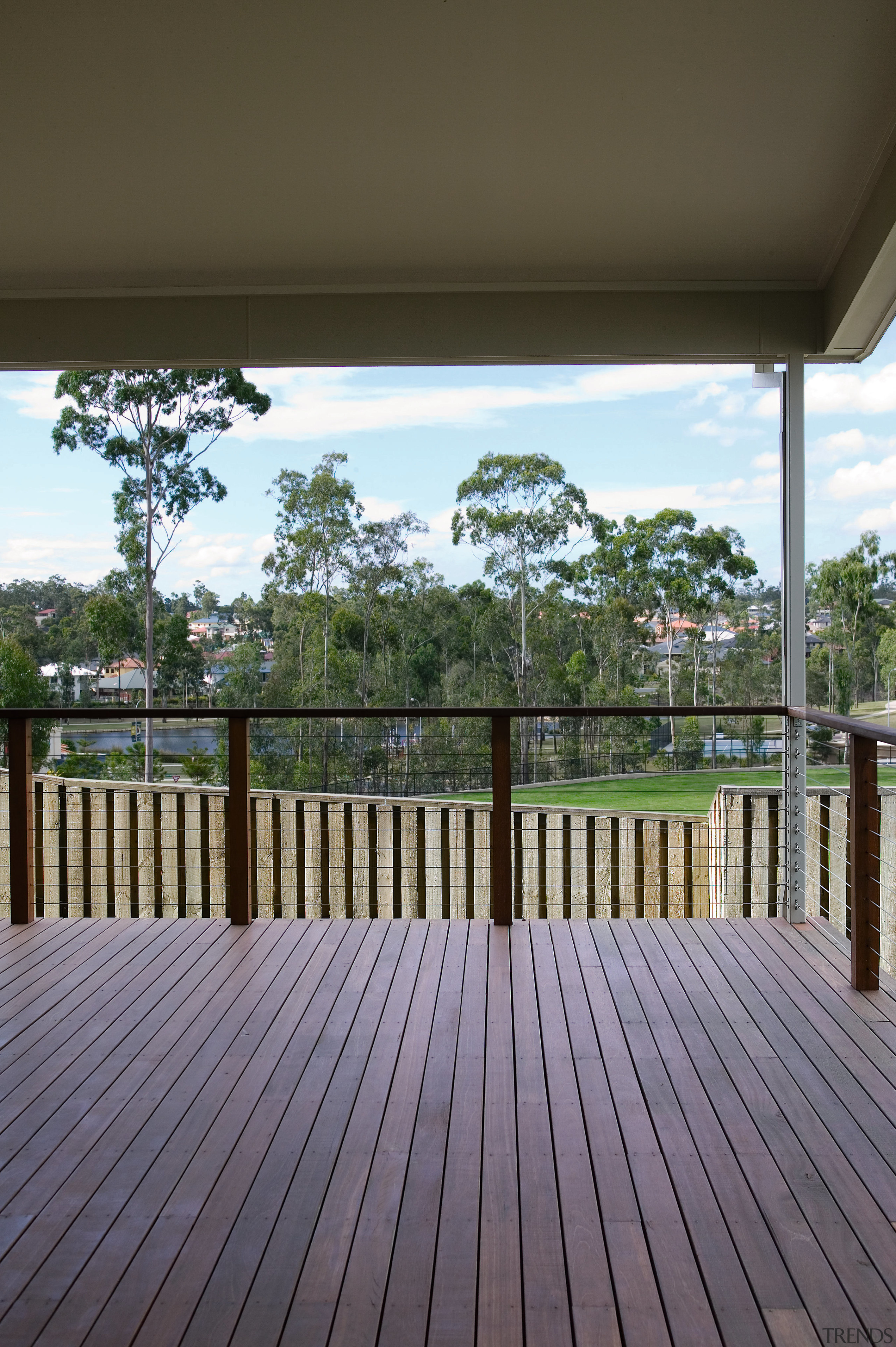 A view of a home developed by Cavalier architecture, deck, estate, floor, home, house, outdoor structure, property, real estate, tree, walkway, wood, gray, brown