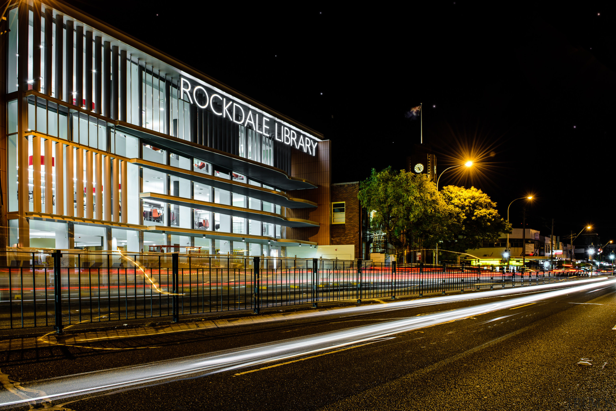 :Located next to the 1940s Rockdale Town Hall, architecture, building, car, city, cityscape, downtown, evening, house, infrastructure, light, lighting, metropolis, metropolitan area, mixed use, night, residential area, road, sky, street, street light, structure, town, urban area, black