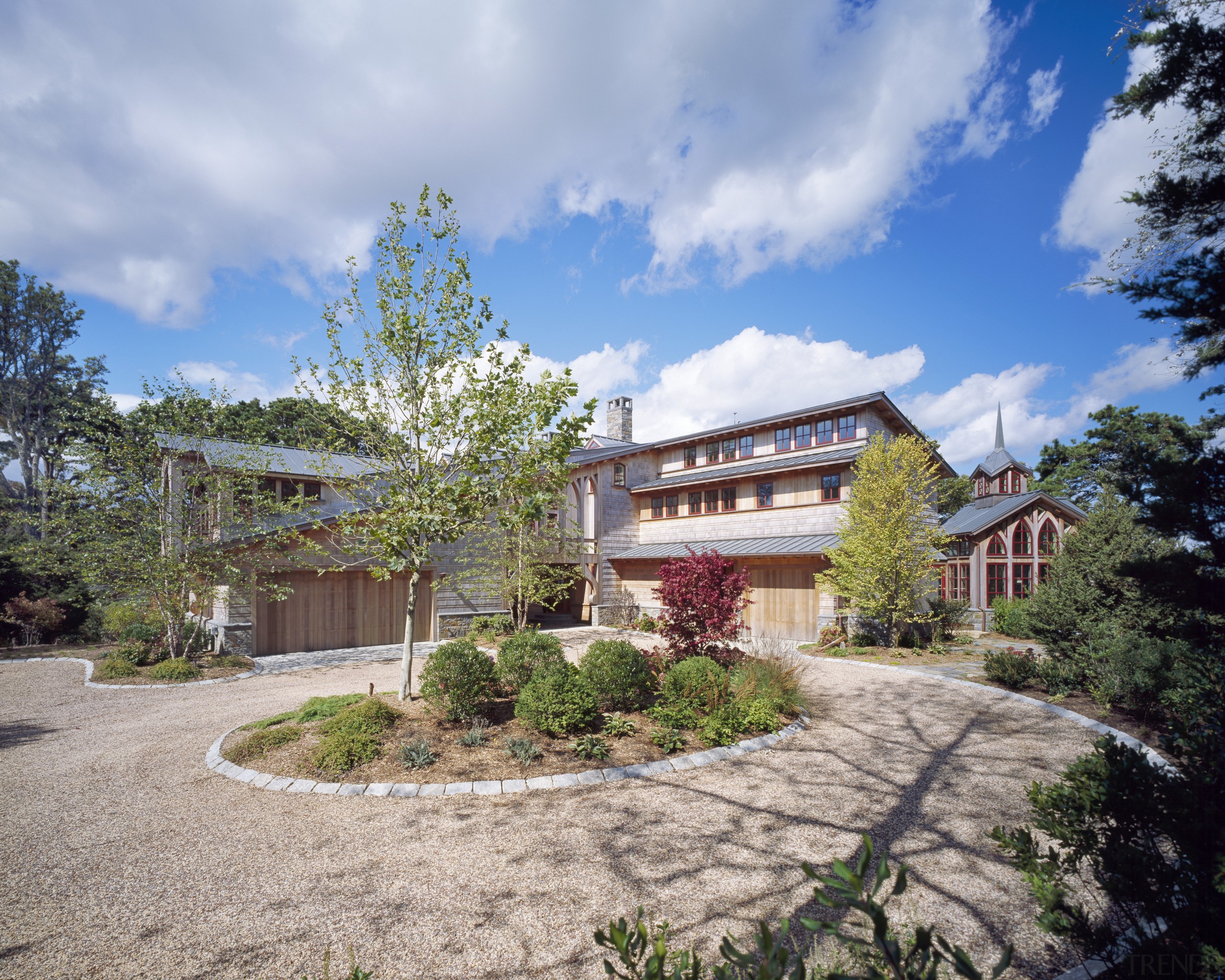 View of multi story home with circular landscape cottage, estate, facade, home, house, property, real estate, residential area, sky, tree, villa, teal