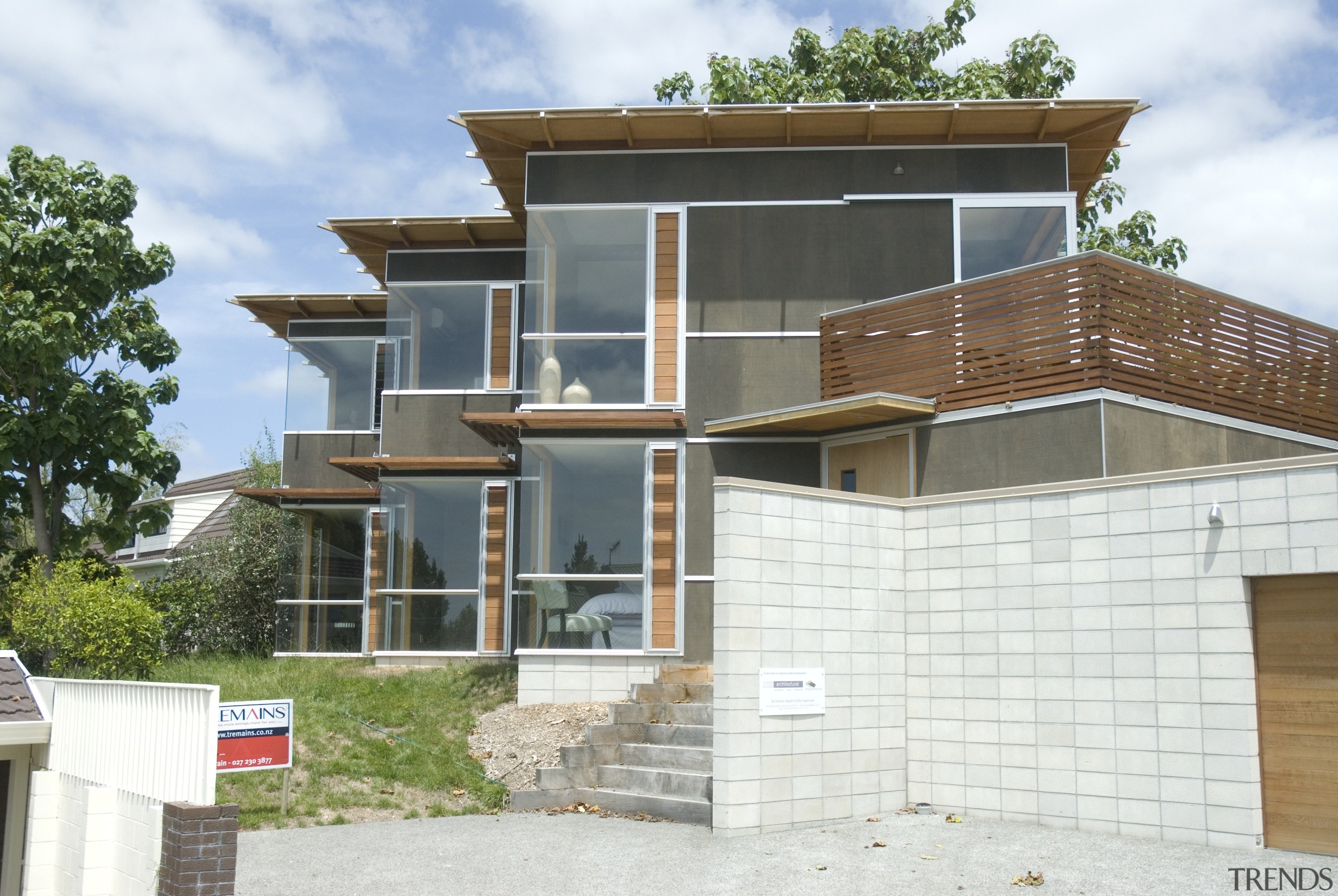 A view of a home built by a architecture, building, elevation, facade, home, house, neighbourhood, property, real estate, residential area, roof, siding, white