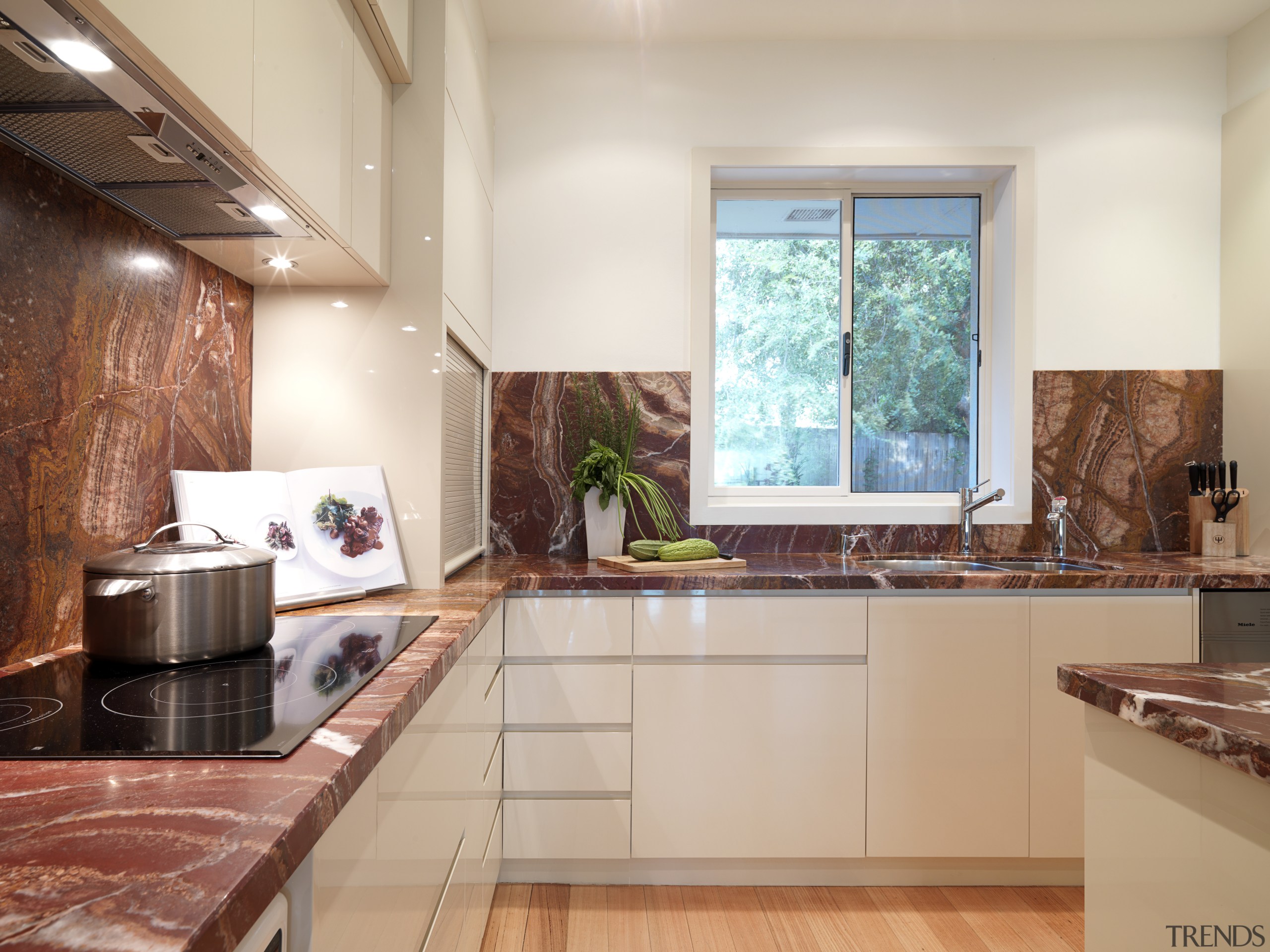 View of contemporary kitchen with light wooden flooring, countertop, interior design, kitchen, real estate, gray