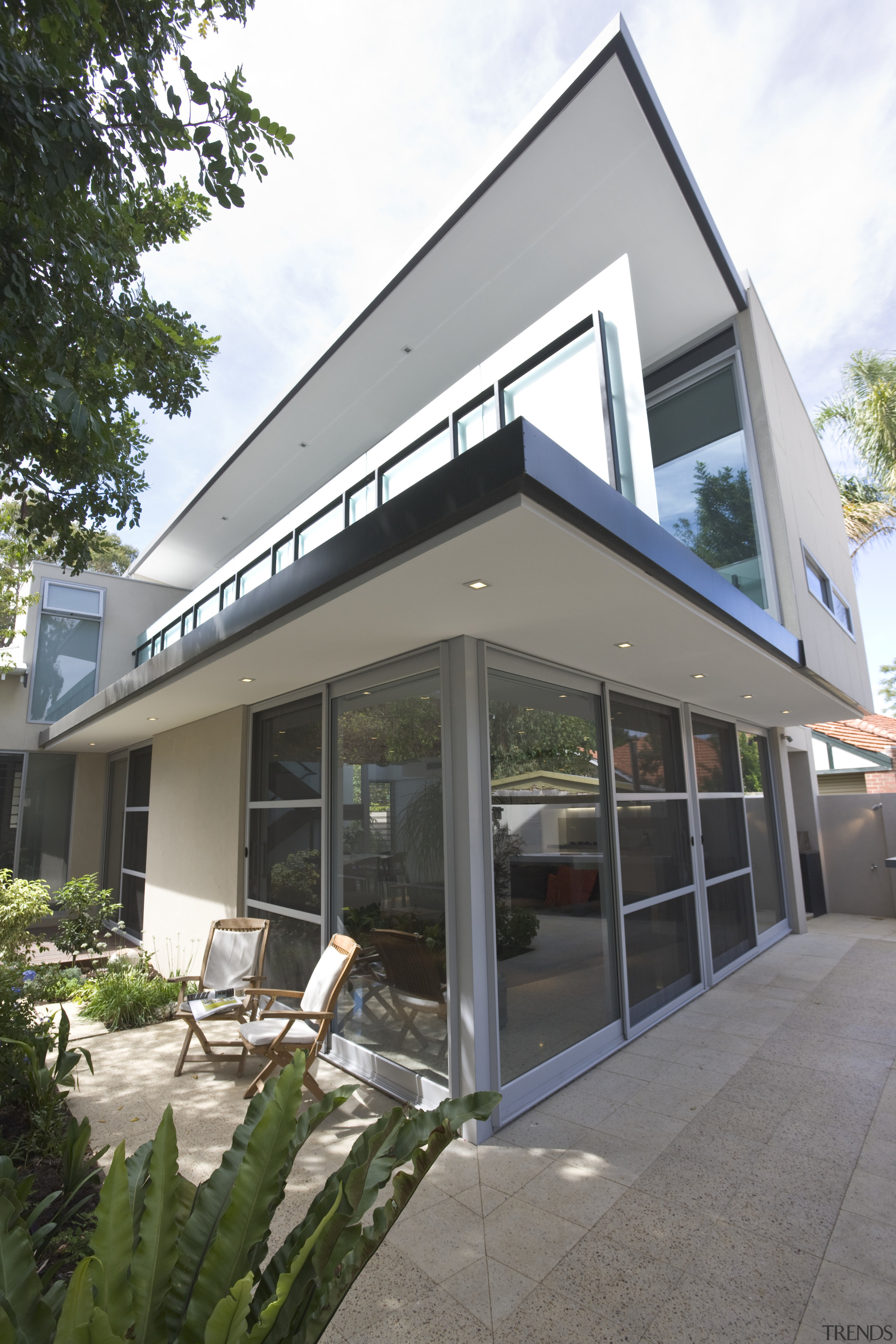 Corner of a contemporary house, sharp design featured architecture, building, facade, home, house, property, real estate, window, white, gray