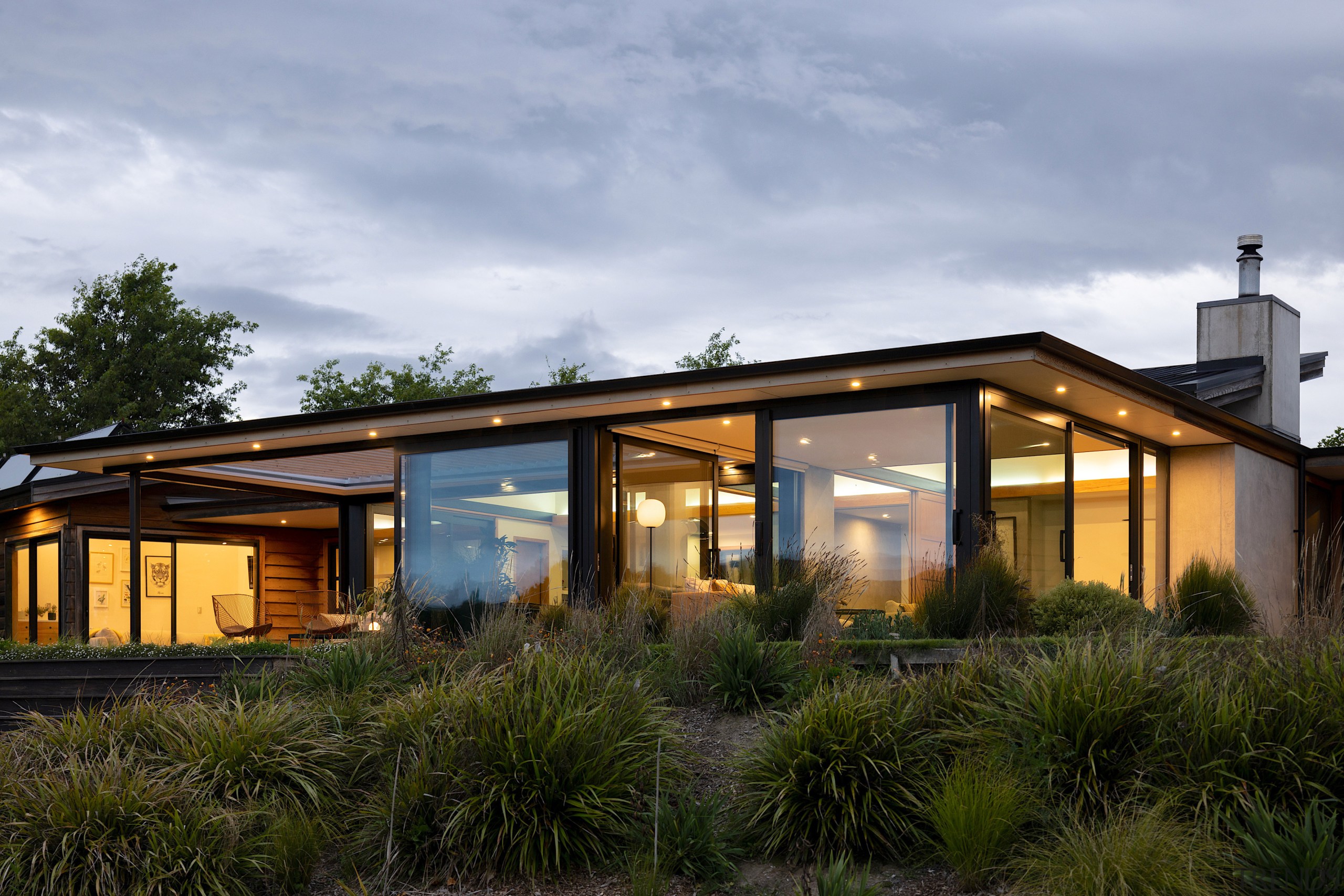 The renovated and extended home at dusk. - 