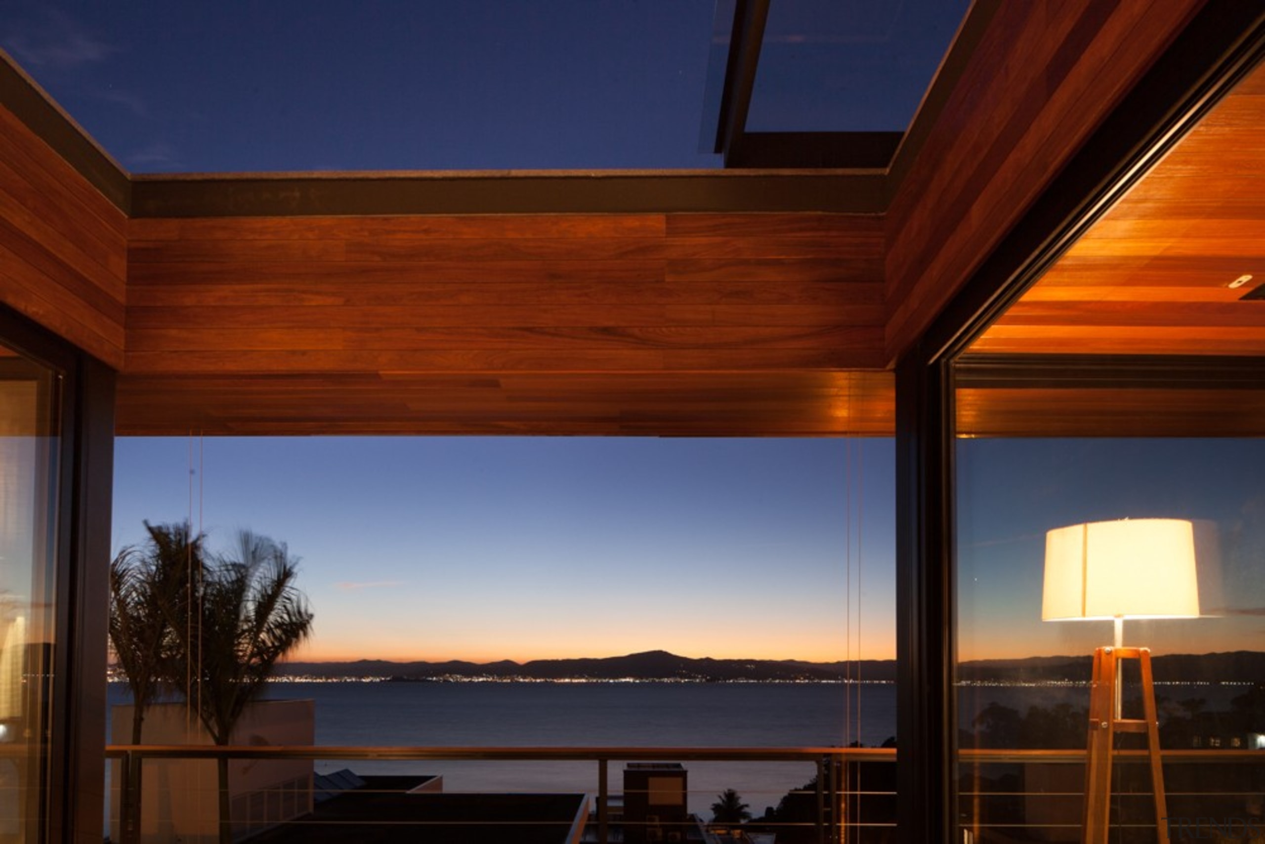 Looking out at sunset - apartment | architecture apartment, architecture, ceiling, daylighting, estate, evening, home, house, interior design, lighting, property, real estate, reflection, roof, sky, sunlight, window, wood, red