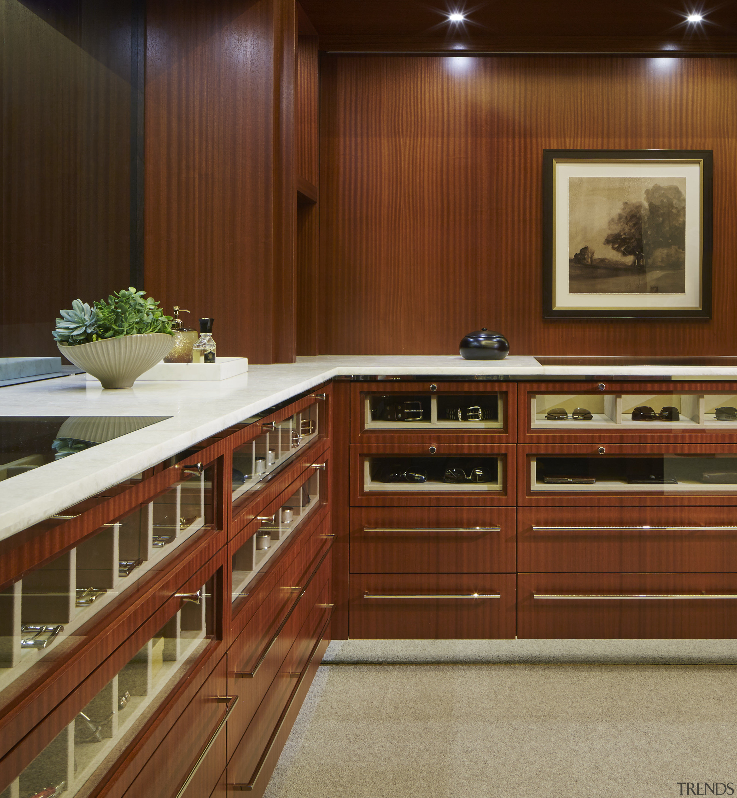 This extensive closet space features custom-designed storage on cabinetry, countertop, flooring, furniture, interior design, kitchen, wood, brown