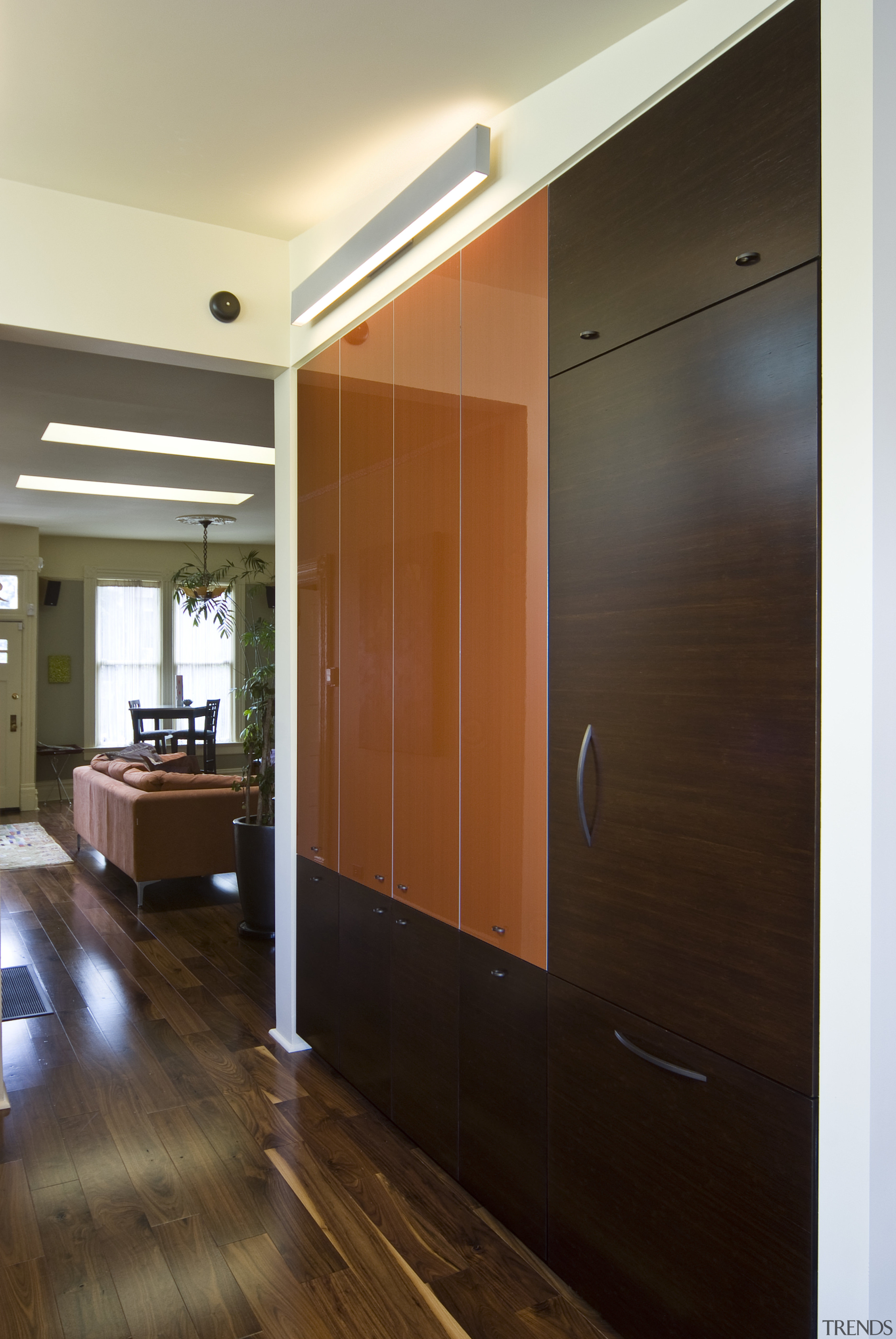 View of kitchen which features custom refrigerator cabinetry. cabinetry, ceiling, door, floor, flooring, hardwood, interior design, room, wall, wood, wood flooring, brown