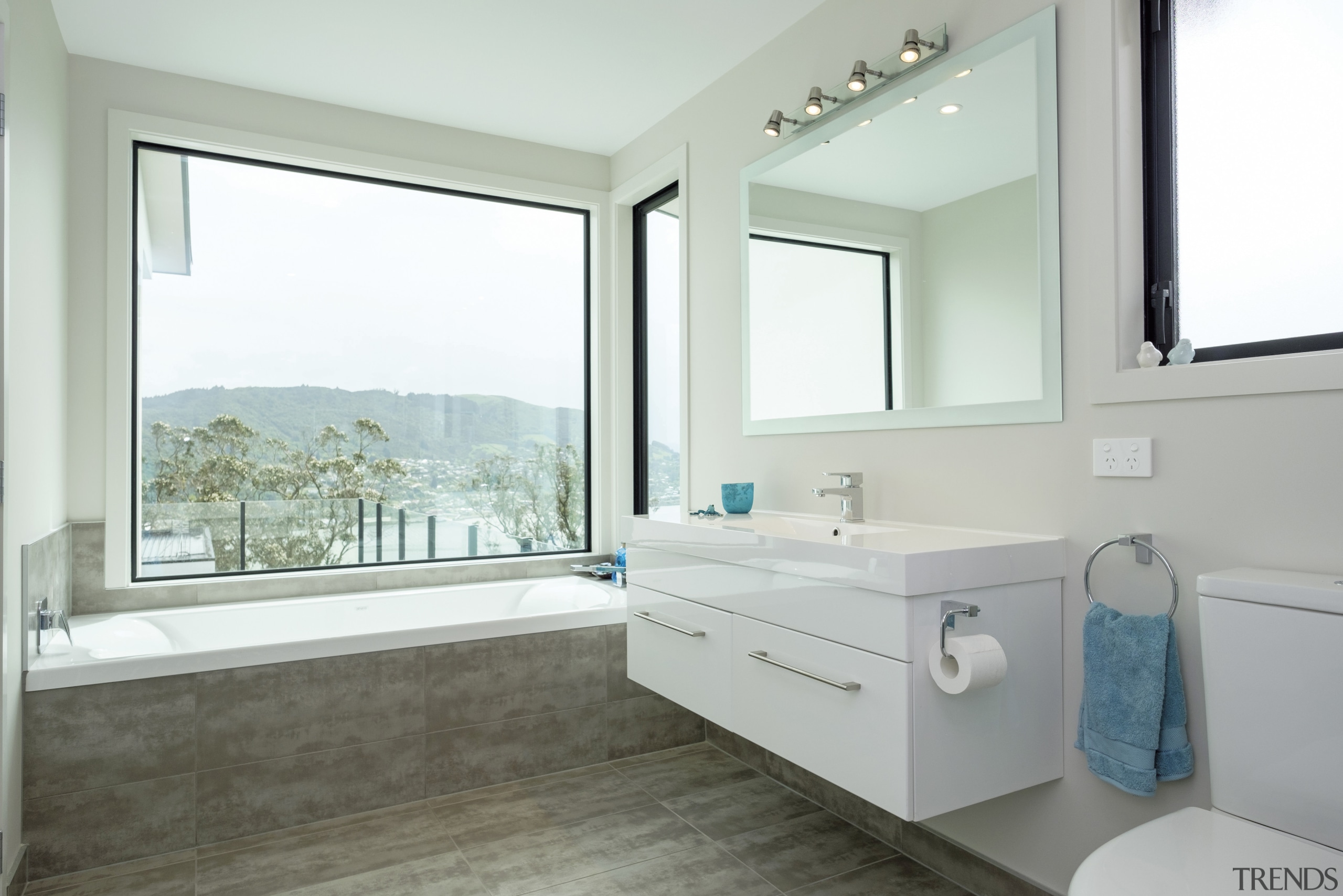 This coastal residences two bathrooms are both trained bathroom, bathroom accessory, estate, floor, home, interior design, property, real estate, room, window, white, gray