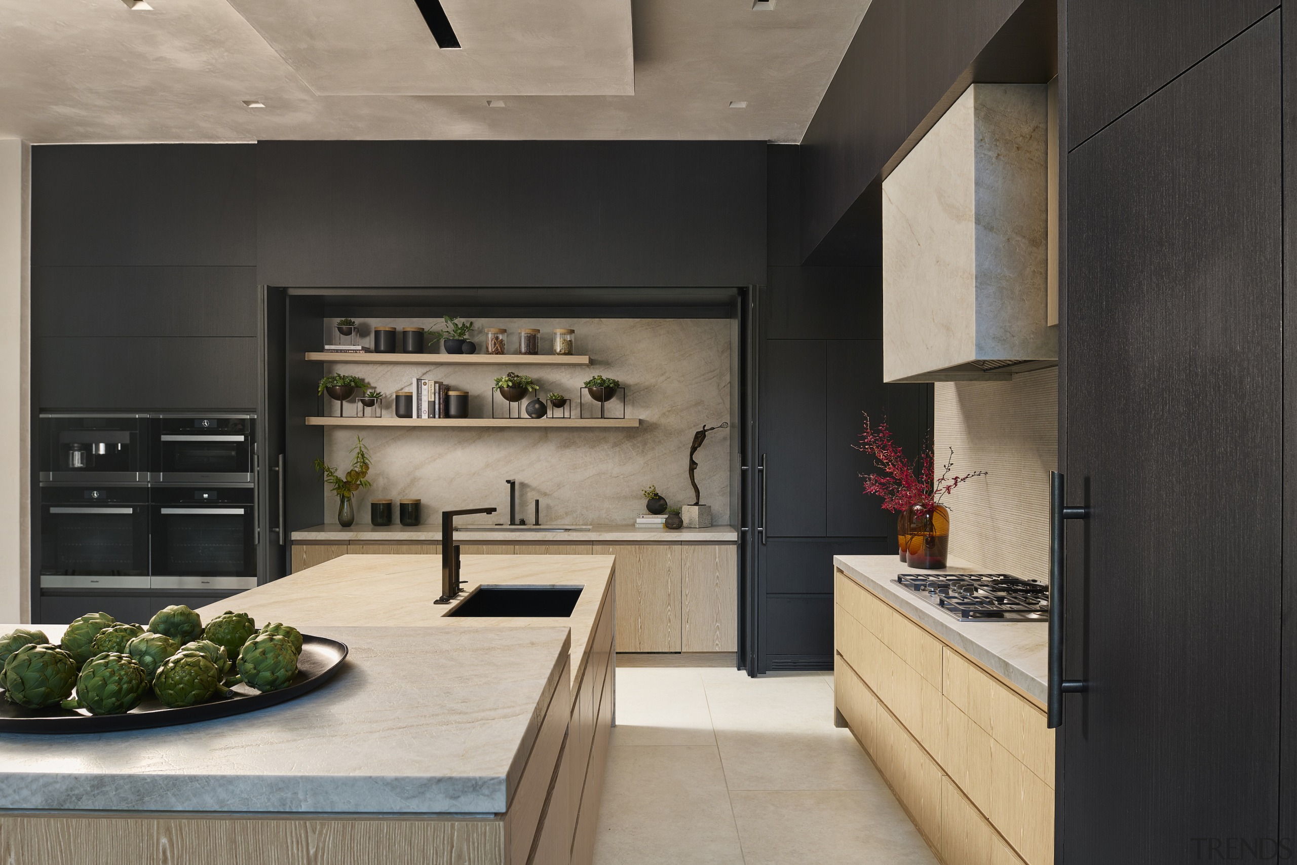 Charcoal and light tan tones give the kitchen 