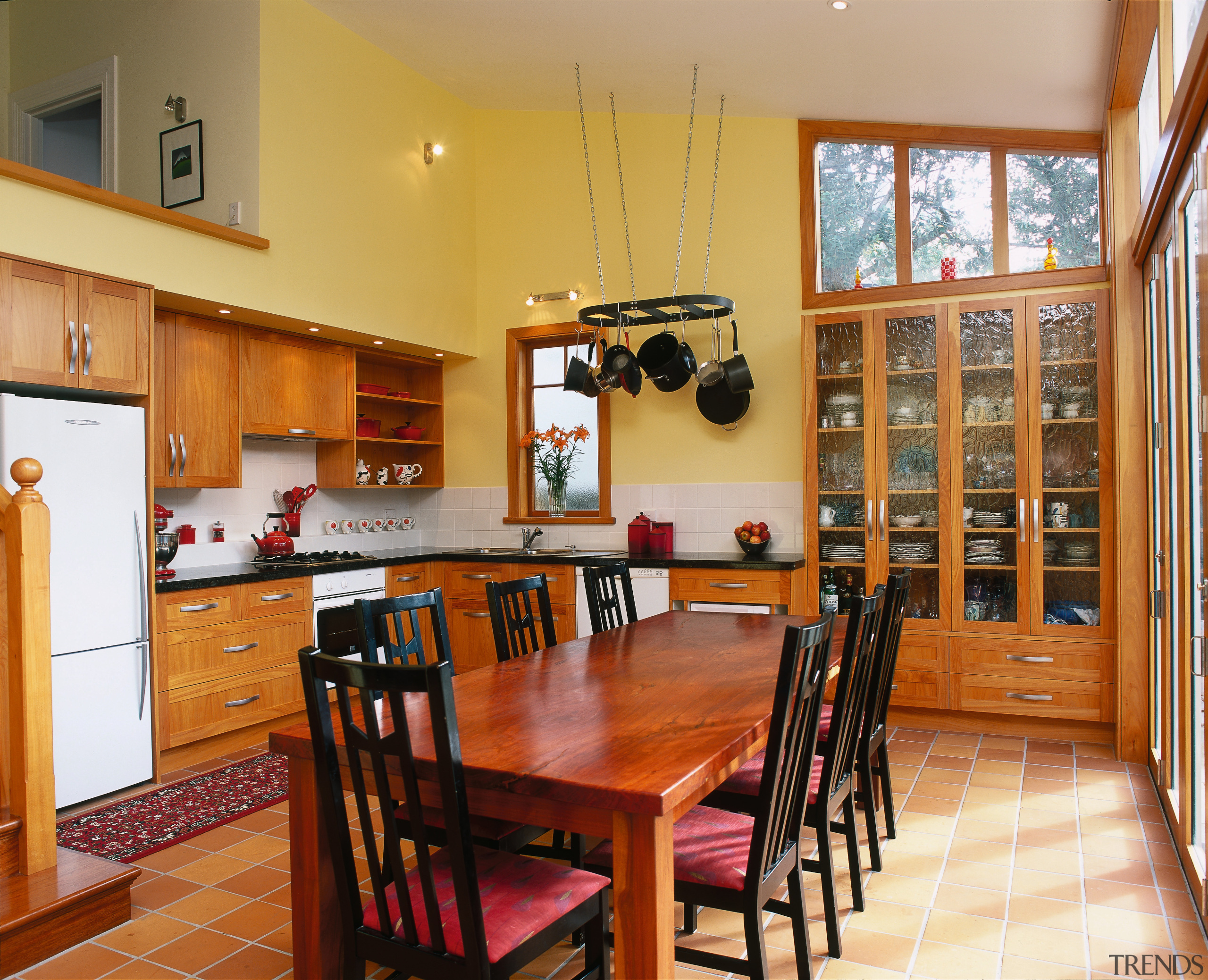 Traditional kitchen with macrocarpa cabinetry, glass doors in dining room, flooring, hardwood, interior design, kitchen, property, real estate, room, table, wood, orange, brown