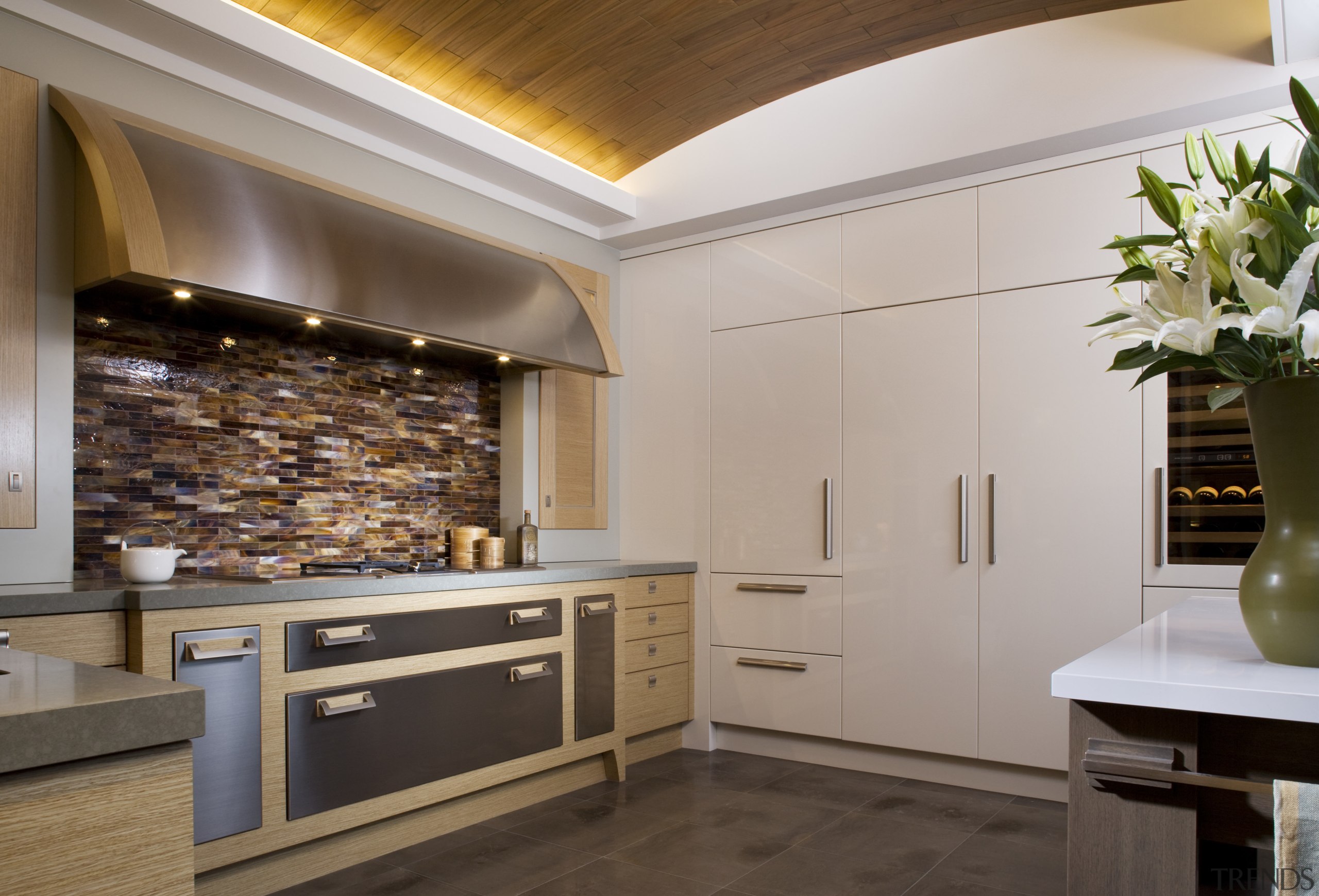 View of a kitchen designed and built by cabinetry, ceiling, countertop, cuisine classique, floor, flooring, interior design, kitchen, gray, brown