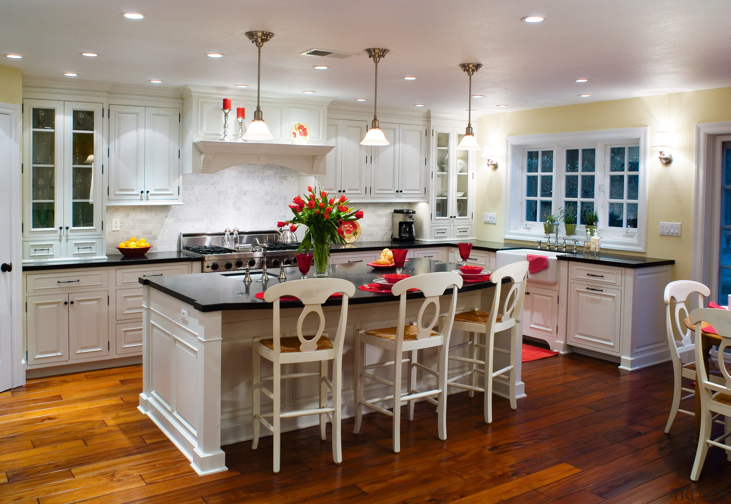 A view of this kitchen featuring white timber cabinetry, countertop, cuisine classique, dining room, floor, flooring, hardwood, interior design, kitchen, room, wood flooring, gray