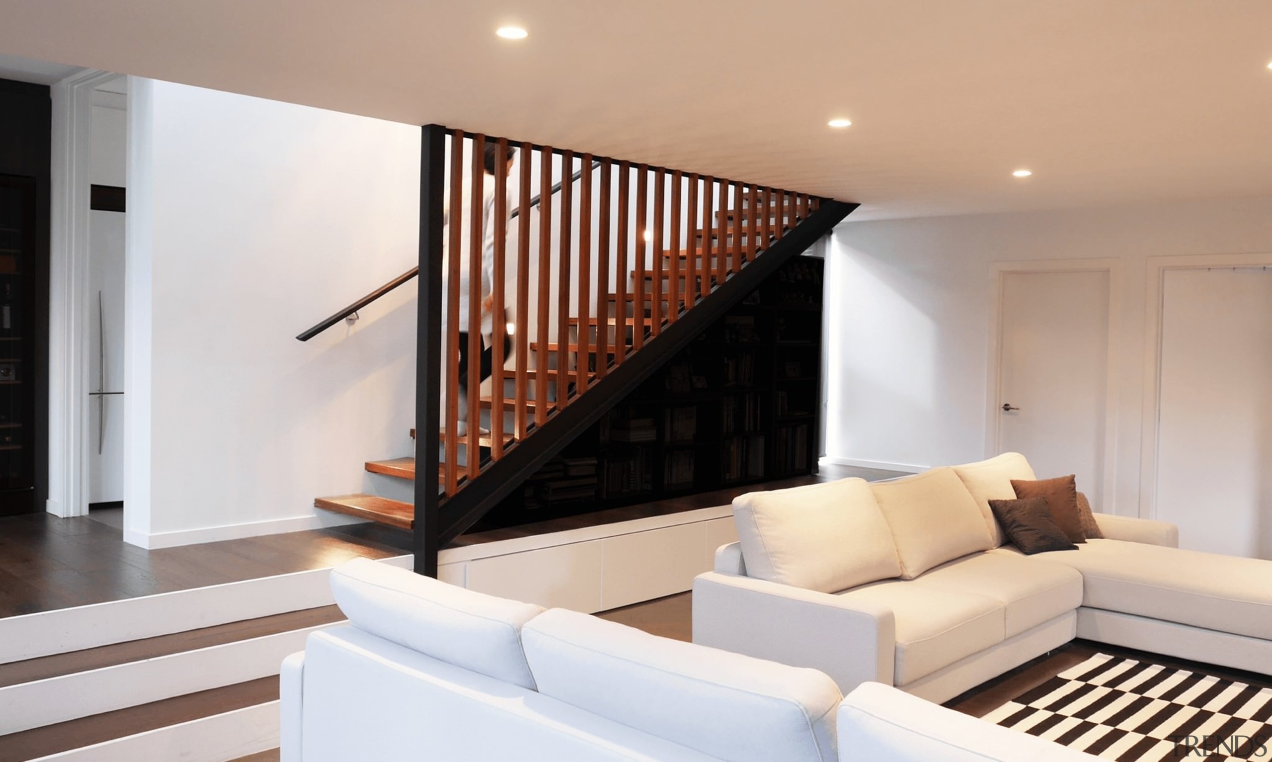 The sunken living room is just one of architecture, estate, floor, flooring, handrail, hardwood, home, house, interior design, living room, property, real estate, stairs, wood flooring, gray