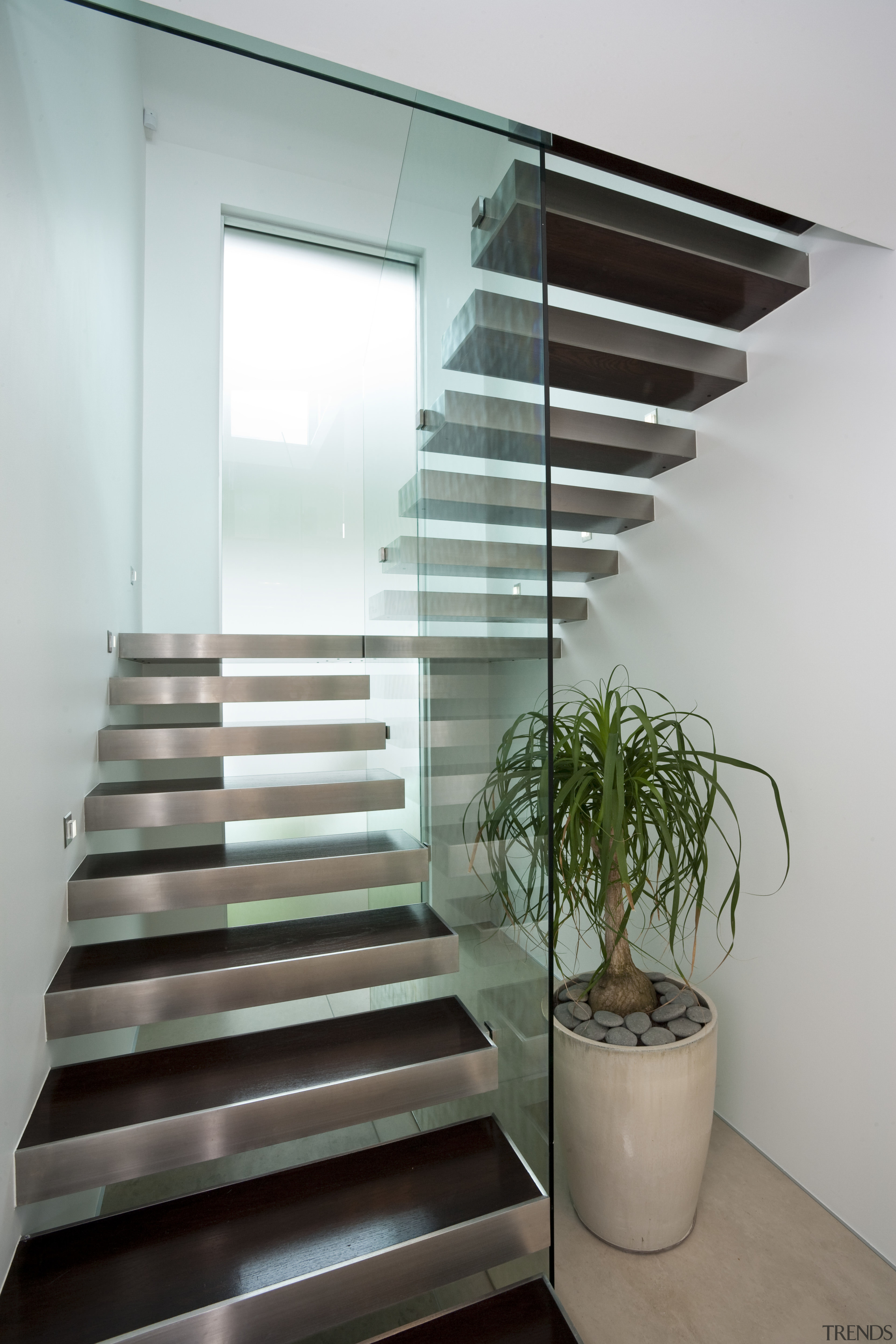 View of a stairway which features glass balustrades daylighting, glass, handrail, interior design, product design, stairs, gray