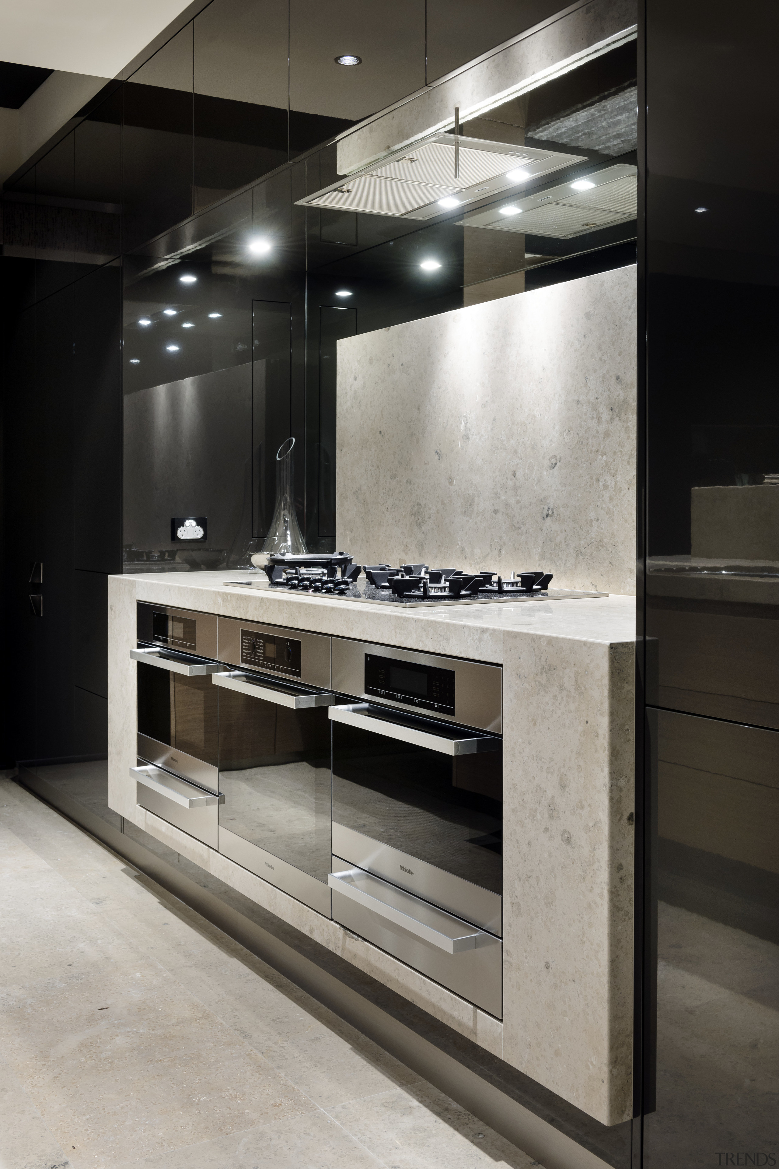 The black lacquered cabinets in this kitchen contain interior design, gray, black